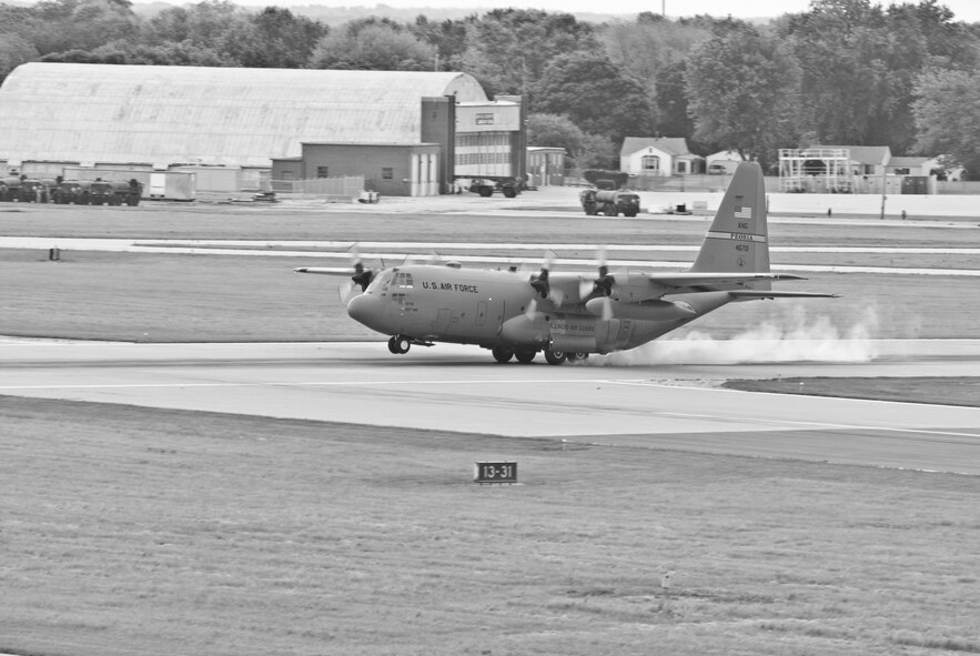 An Illinois Air National Guard C-130H3 Hercules aircraft touches down on a runway at the 182nd Airlift Wing in Peoria, Ill., June 2, 2013.  The military transport plane participated in a rare seven-ship taxi in which seven aircraft from the Air National Guard base flew together simultaneously in formation.  (U.S. Air National Guard photo by Staff Sgt. Lealan Buehrer/Released)