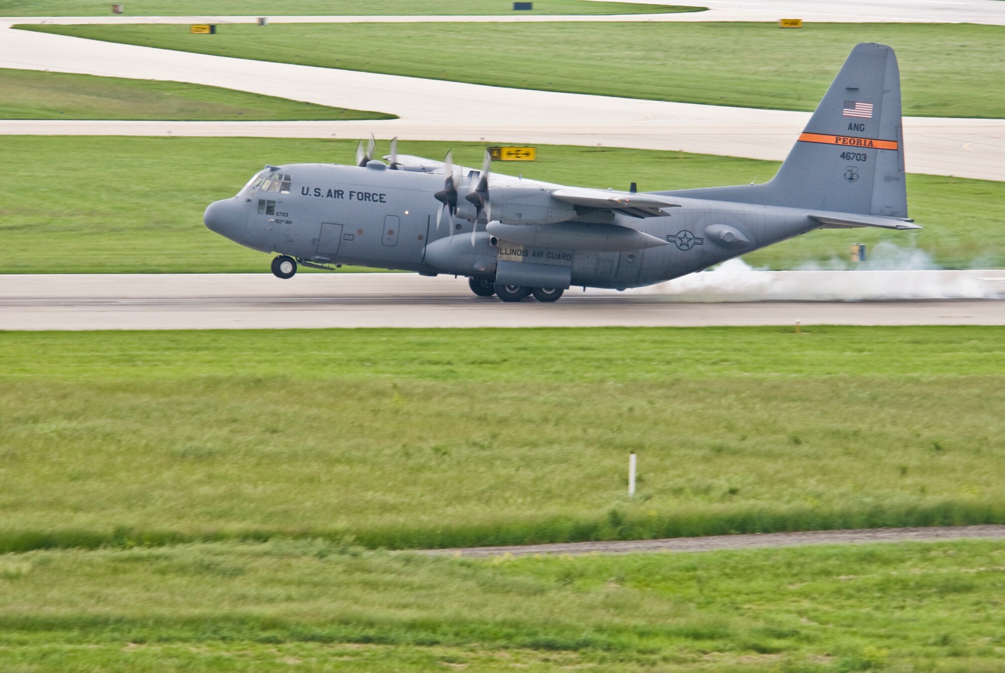 An Illinois Air National Guard C-130H3 Hercules aircraft touches down on a runway at the 182nd Airlift Wing in Peoria, Ill., June 2, 2013.  The military transport plane participated in a rare seven-ship taxi in which seven aircraft from the Air National Guard base flew together simultaneously in formation.  (U.S. Air National Guard photo by Staff Sgt. Lealan Buehrer/Released)