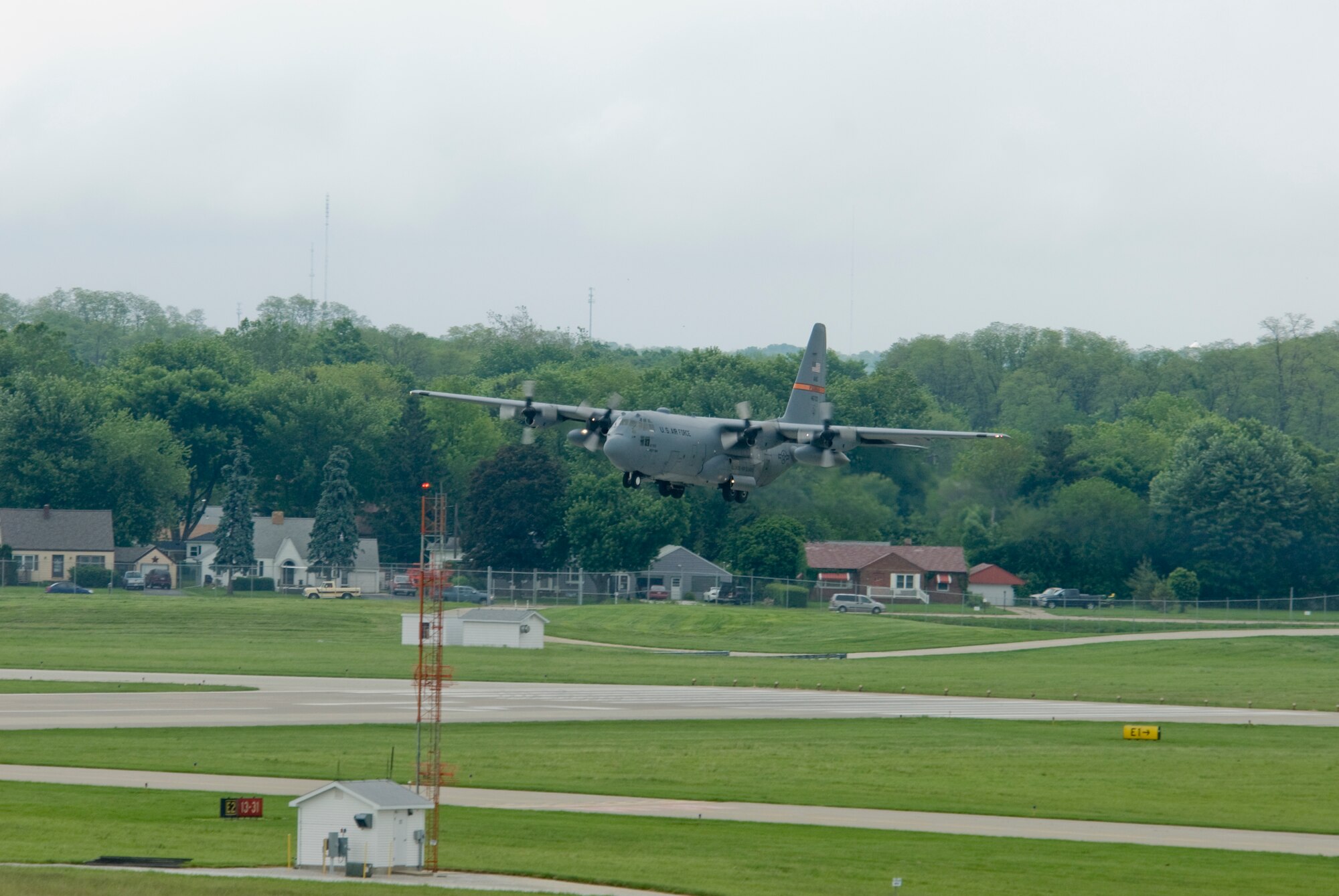 An Illinois Air National Guard C-130H3 Hercules aircraft prepares to land on a runway at the 182nd Airlift Wing in Peoria, Ill., June 2, 2013.  The military transport plane participated in a rare seven-ship taxi in which seven aircraft from the Air National Guard base flew together simultaneously in formation.  (U.S. Air National Guard photo by Staff Sgt. Lealan Buehrer/Released)