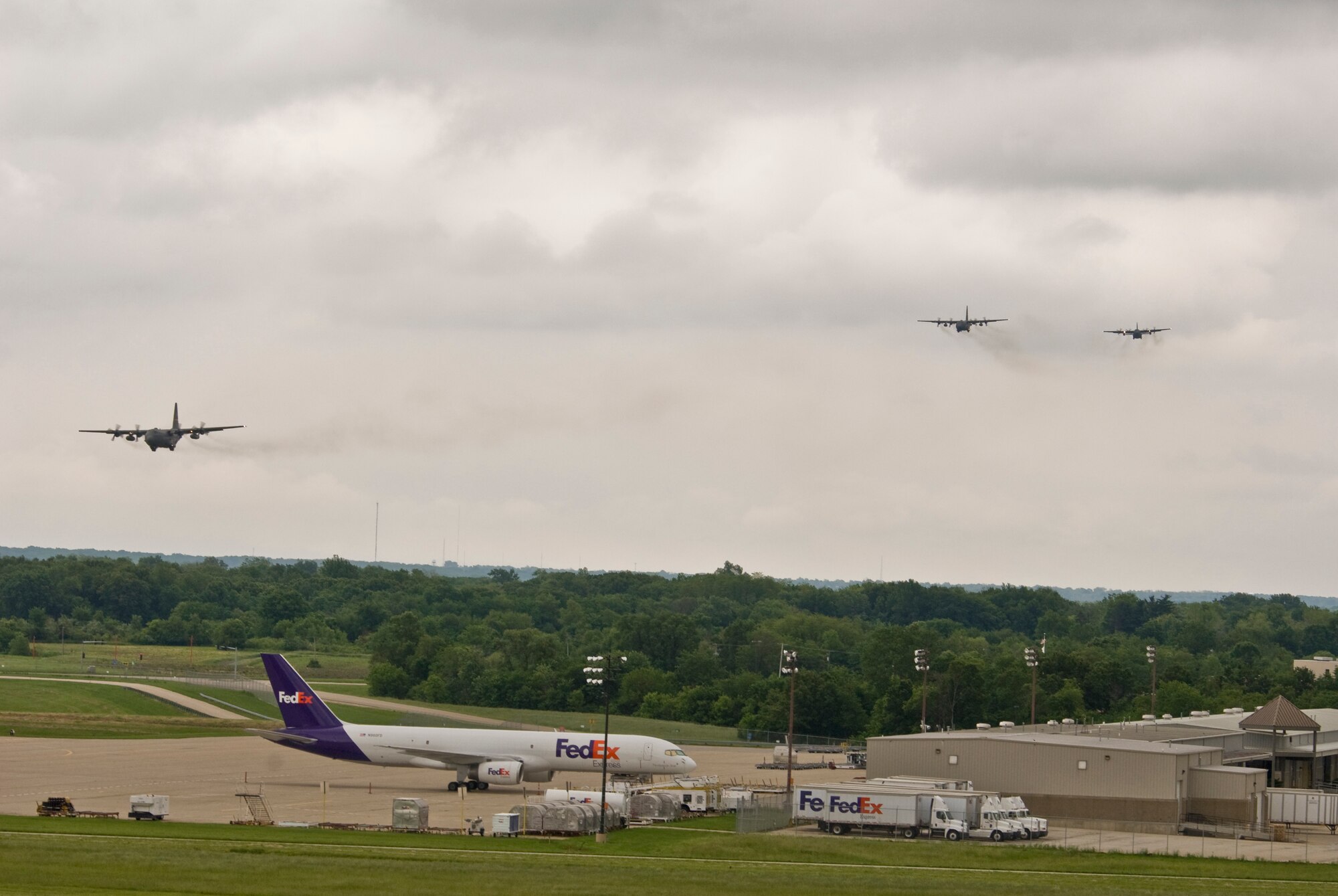 Three Illinois Air National Guard C-130H3 Hercules aircraft come on final approach at the 182nd Airlift Wing in Peoria, Ill., June 2, 2013.  The military transport planes participated in a rare seven-ship taxi in which seven aircraft from the Air National Guard base flew together simultaneously in formation.  (U.S. Air National Guard photo by Staff Sgt. Lealan Buehrer/Released)