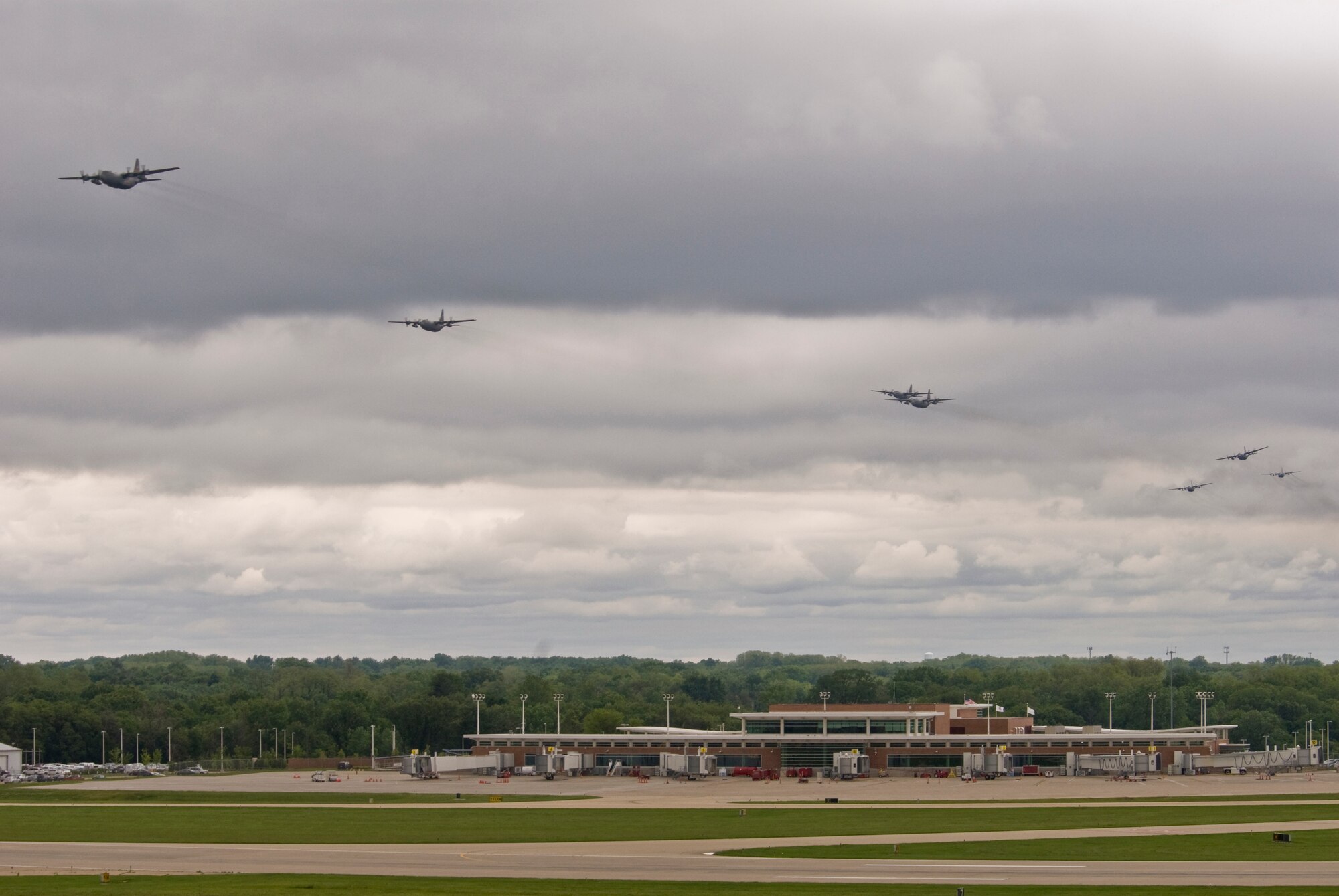 Illinois Air National Guard C-130H3 Hercules aircraft conduct a flyby over the 182nd Airlift Wing in Peoria, Ill., June 2, 2013.  The military transport planes participated in a rare seven-ship taxi in which seven aircraft from the Air National Guard base flew together simultaneously in formation.  (U.S. Air National Guard photo by Staff Sgt. Lealan Buehrer/Released)