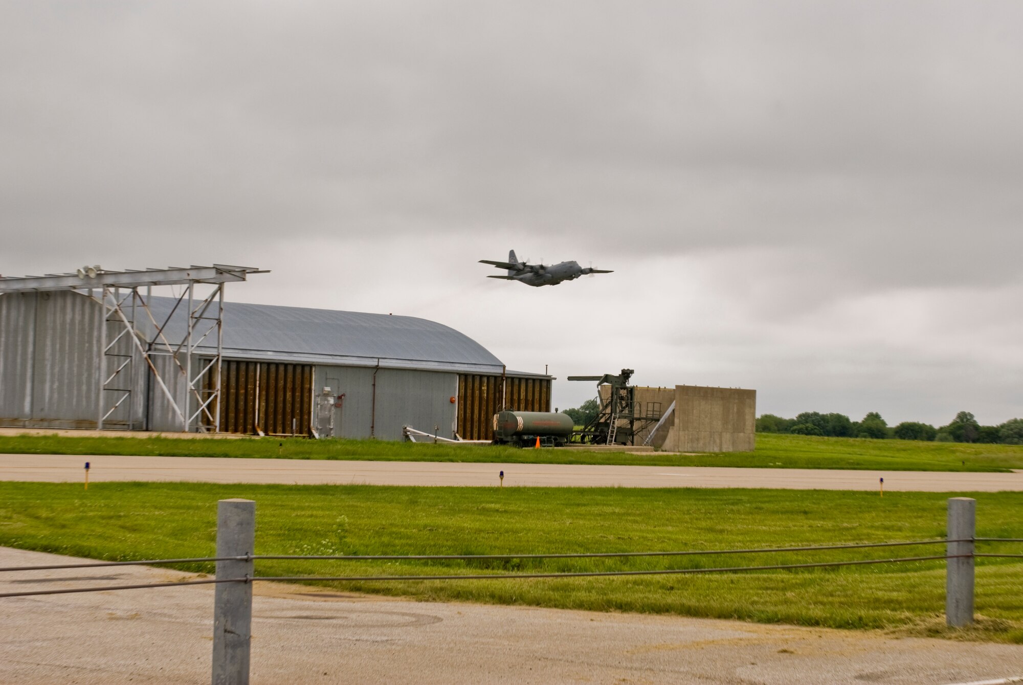 An Illinois Air National Guard C-130H3 Hercules aircraft takes flight over the 182nd Airlift Wing in Peoria, Ill., June 2, 2013.  The military transport plane participated in a rare seven-ship taxi in which seven aircraft from the Air National Guard base flew together simultaneously in formation.  (U.S. Air National Guard photo by Staff Sgt. Lealan Buehrer/Released)