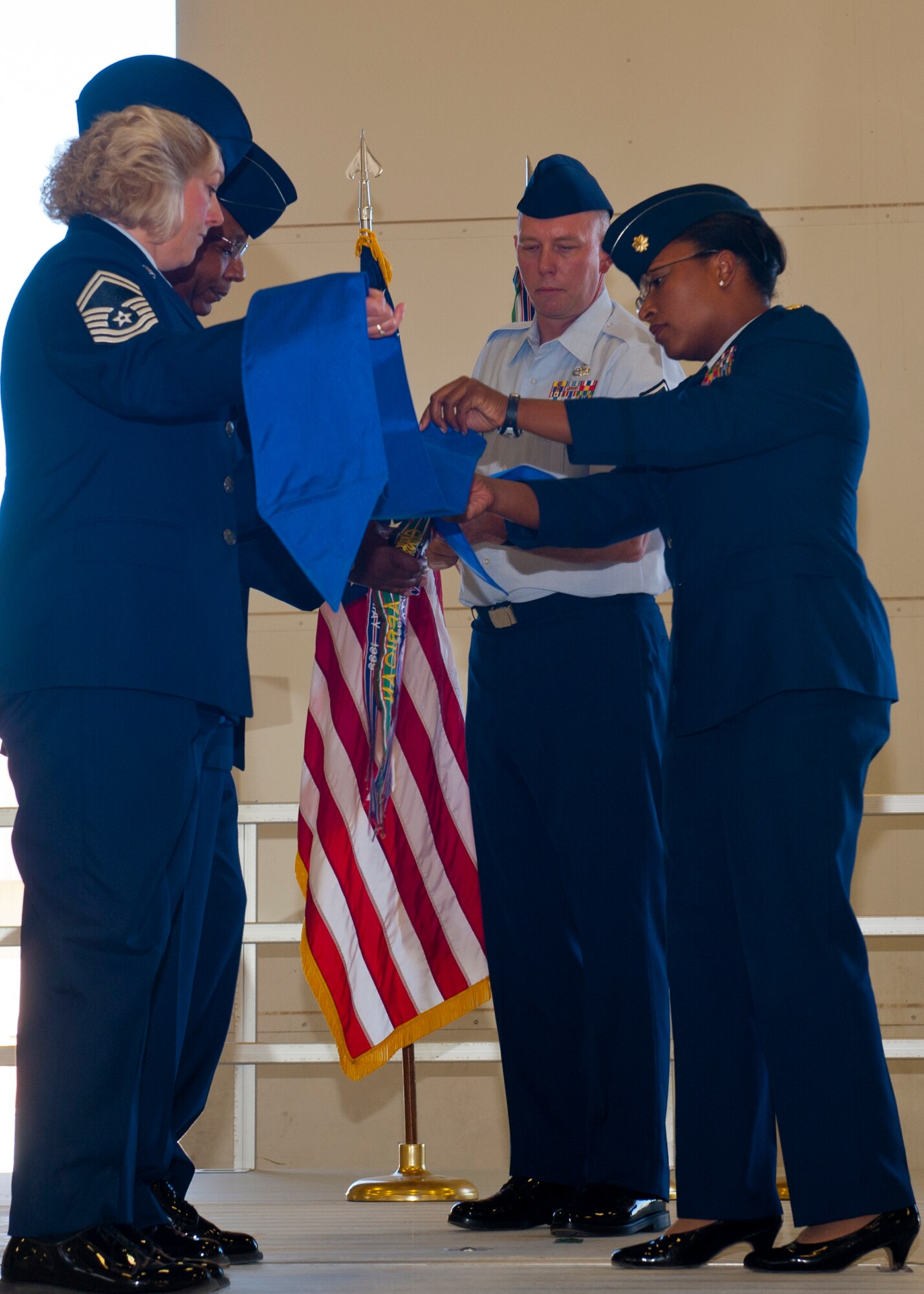 Maj. Jeurney Meekins, 49th Maintenance Operations Squadron commander, covers the guidon at Holloman Air Force Base, N.M., June 4. The covering of the guide on represents the deactivation of the 49th MOS, which will become a part of the 849th Aircraft Maintenance Squadron. (U.S. Air Force photo by Airman 1st Class Leah Murray/Released)  