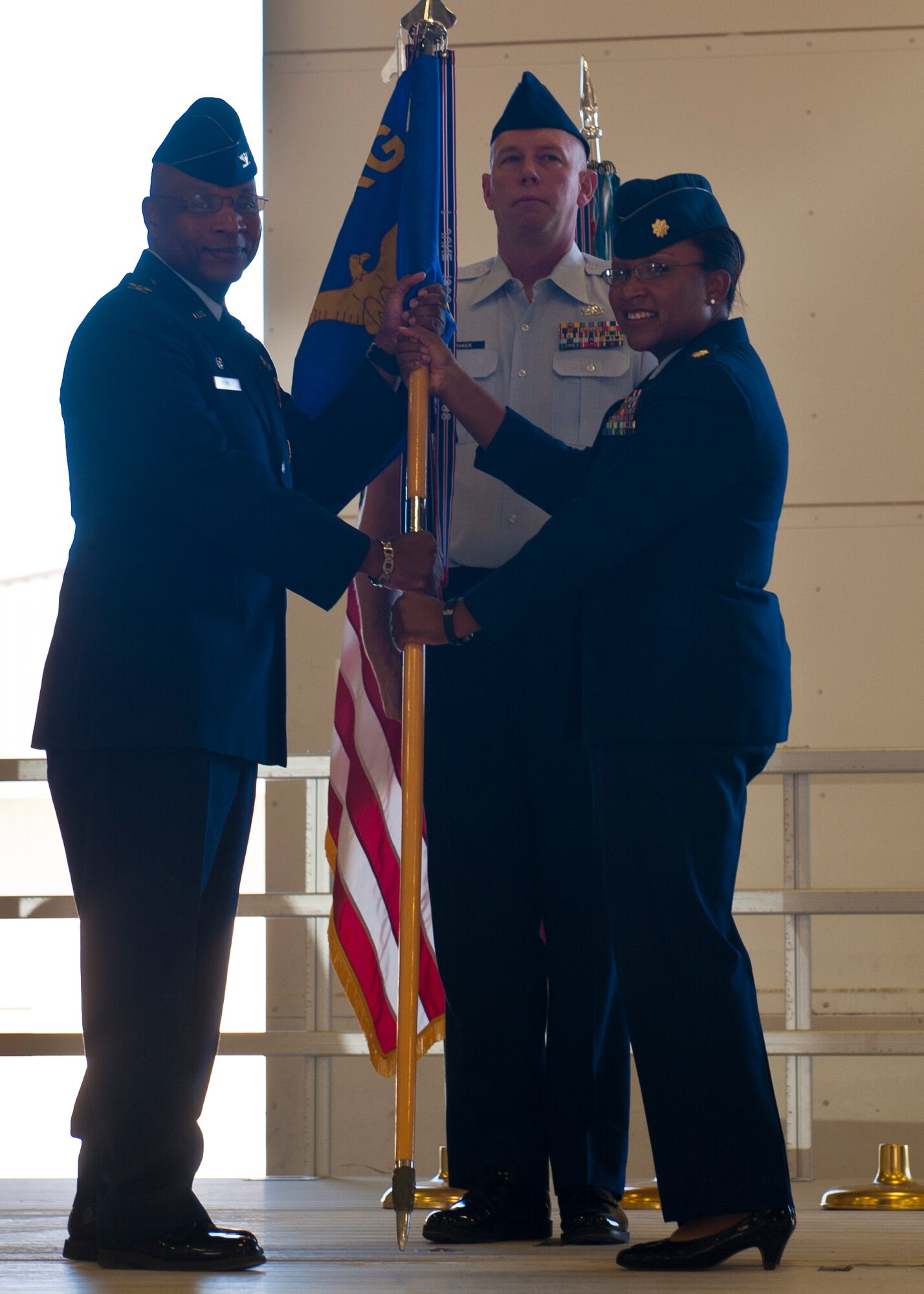 Maj. Jeurney Meekins, 49 Maintenance Operations Squadron commander, passes off the guidon to Col. Andre Kennedy, 49th Maintenance Group commander, at Holloman Air Force Base, N.M., June 4. The squadron will become part of the 849th Aircraft Maintenance Squadron. (U.S. Air Force photo by Airman 1st Class Leah Murray/Released)  