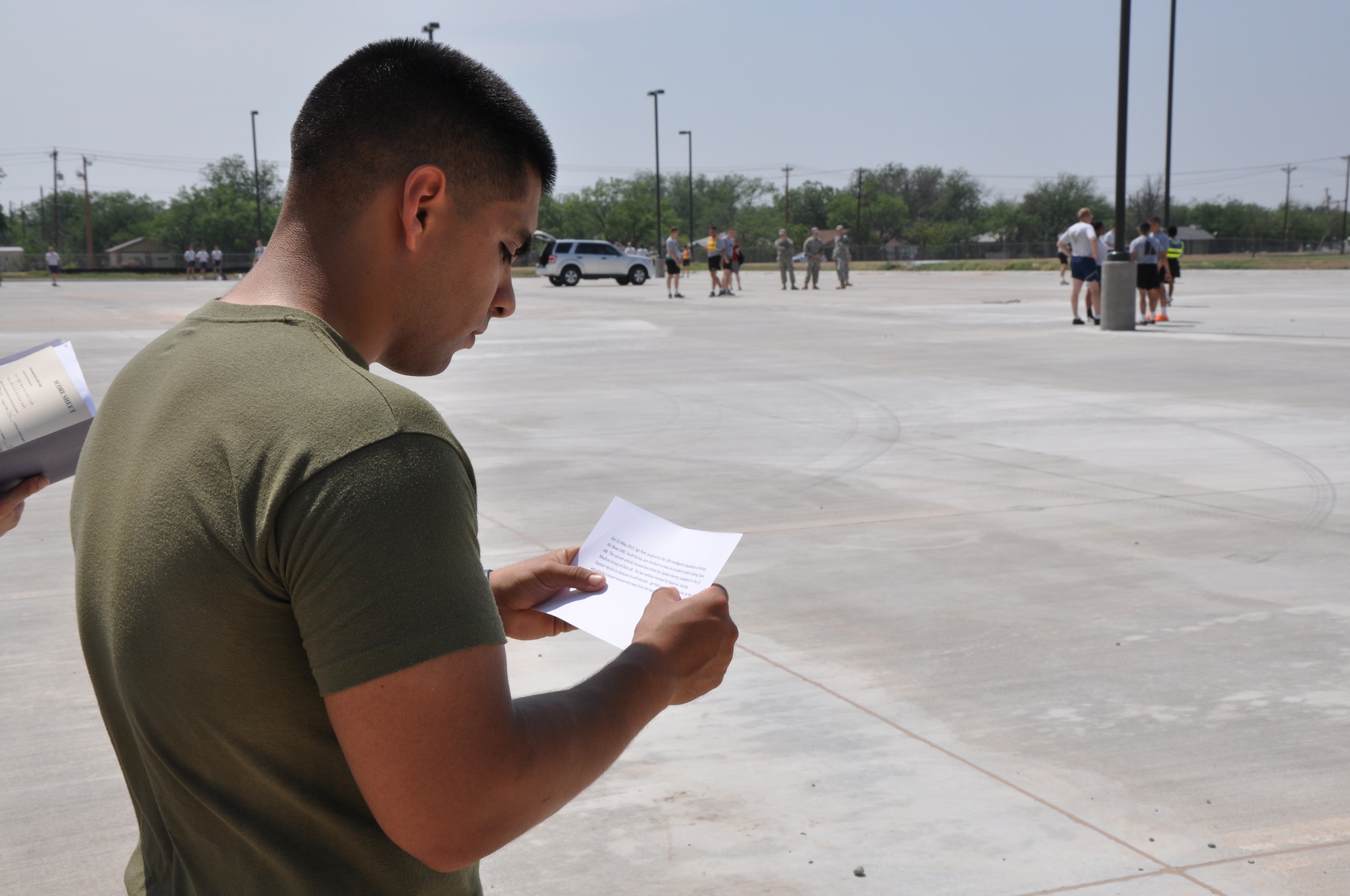 GOODFELLOW AIR FORCE BASE, Texas – Marine Cpl. Jonathan Hilzinger, Marine Corps Detachment student, reads an English passage for the telephone relay during the 316th Training Squadron Language Competition at the parking lot on the north side of Ft. Lancaster Avenue, May 24. Once Hilzinger finished memorizing the passage, he had to run a lap around the parking lot while translating the passage, before passing it on to the next person on his team. (U.S. Air Force photo/ Airman 1st Class Joshua Edwards)