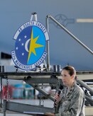 Lt. Col Tracey Smith, 437th Maintenance Squadron commander, unveiled the squadron's new emblem during a ceremony May 30, 2013, at Joint Base Charleston – Air Base, S.C. This is the first change to the squadron’s emblem since 1966. The Ultramarine Blue and Air Force Yellow represent the U.S. Air Force colors. Blue alludes to the sky, the primary theater of Air Force operations and the yellow refers to the sun and the excellence required of Air Force personnel. The background of day and night sky indicates around-the-clock maintenance operations. The sun resembles a compass rose, symbolizing the squadron's mission of support in keeping the unit's aircraft flying worldwide. The stars are in a constellation cluster, representing the teamwork required among active duty and Air Reserve component officer and enlisted members and civilians to make the mission happen. The Latin motto, "Ad Exacta Capaces” expresses the spirit of the 437th MXS personnel. (U.S. Air Force photo/Master Sgt. Perry Woods)