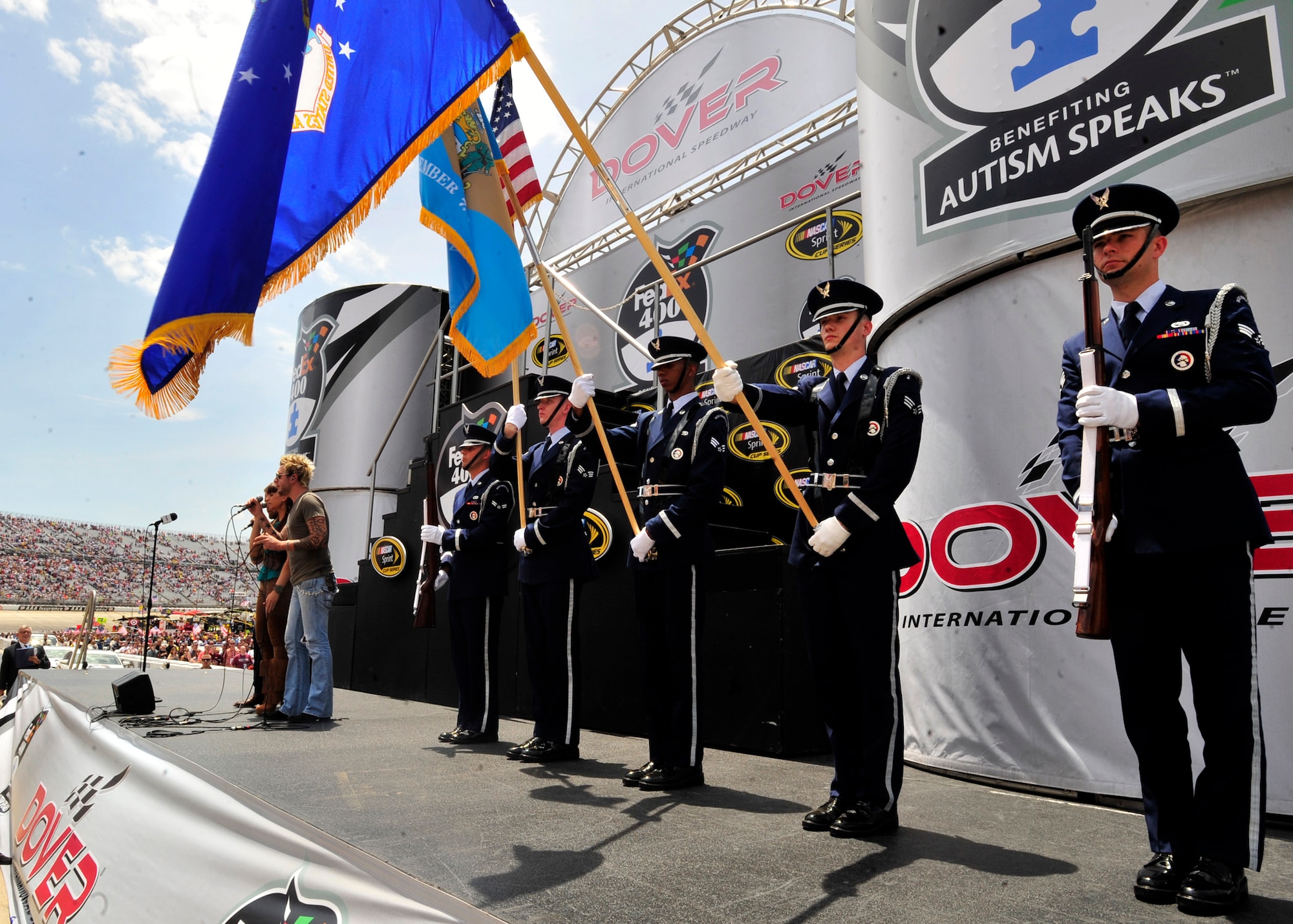 Members of the Dover Air Force Base Honor Guard present the colors during the National Anthem before the start of the Fed Ex 400 Benefiting Autism Speaks June 2, 2013, at Dover International Speedway in Dover, Del. Team Dover members participated in a variety of activities that helped make the race a success. (U.S. Air Force photo/Tech. Sgt. Chuck Walker)