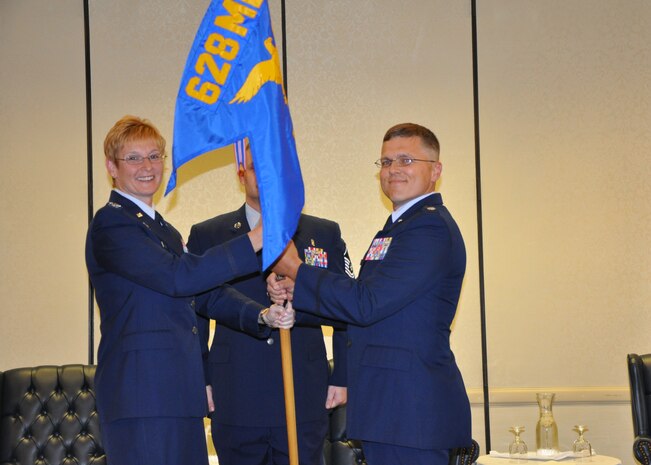 Col. Judi Hughes, 628th Medical Group commander, passes the squadron guidon to Lt. Col. Matthew Krauchunas, 628th Medical Support Squadron commander, during the 628th MDSS change of command ceremony May 29, 2013, at Joint Base Charleston – Air Base, S.C. (U.S. Air Force photo/Capt. Jennifer Swann)