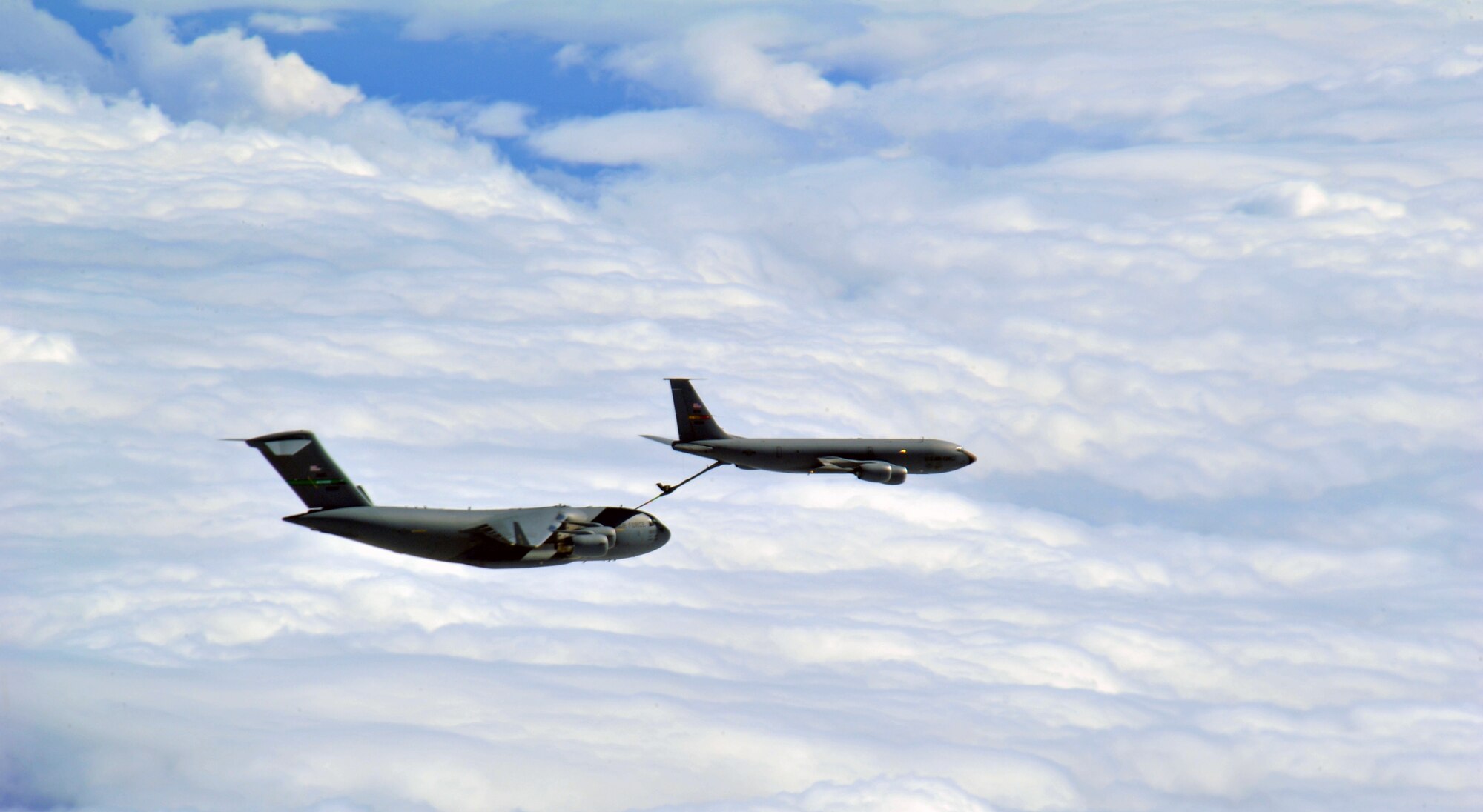 A KC-135 Stratotanker from Fairchild Air Force Base refuels a C-17 Globemaster III from Joint Base Lewis/McChord during an air refueling above Western United States, May 31, 2013. The air refueling was part of a quarterly exercise called Advanced Combat Operations Training. (U.S. Air Force photo by Senior Airman Taylor Curry/Released)
