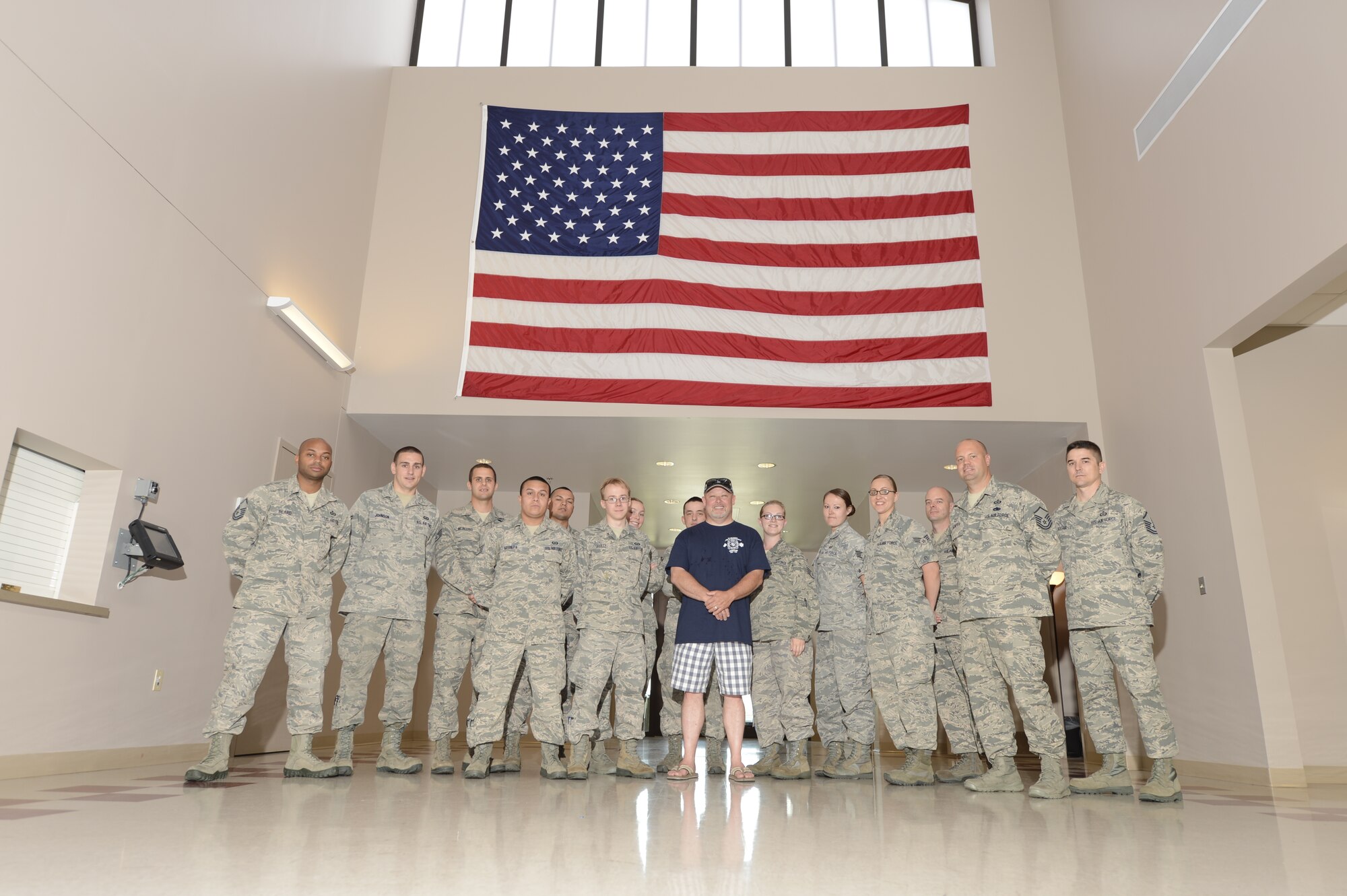 Todd Bodine of ThorSport Racing poses with Airman from the 436th Operations Support Squadron/Aircrew Flight Equipment during a visit to the 436th Airlift Wing May 30, 2013, at Dover Air Force Base, Del. Bodine raced at Dover International Speedway last weekend in the NASCAR Camping World Truck Series Race Lucas Oil 200. (U.S. Air Force photo/Greg L. Davis)