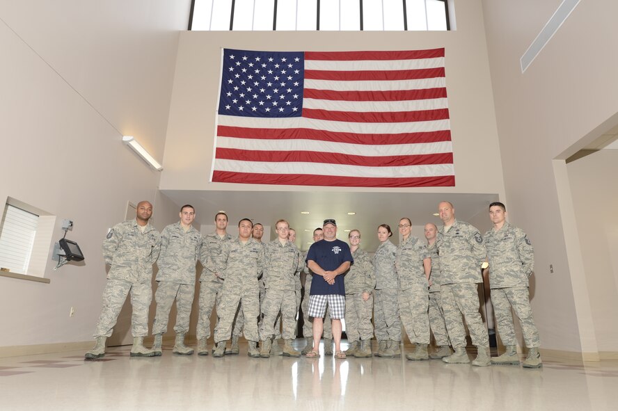 Todd Bodine of ThorSport Racing poses with Airman from the 436th Operations Support Squadron/Aircrew Flight Equipment during a visit to the 436th Airlift Wing May 30, 2013, at Dover Air Force Base, Del. Bodine raced at Dover International Speedway last weekend in the NASCAR Camping World Truck Series Race Lucas Oil 200. (U.S. Air Force photo/Greg L. Davis)