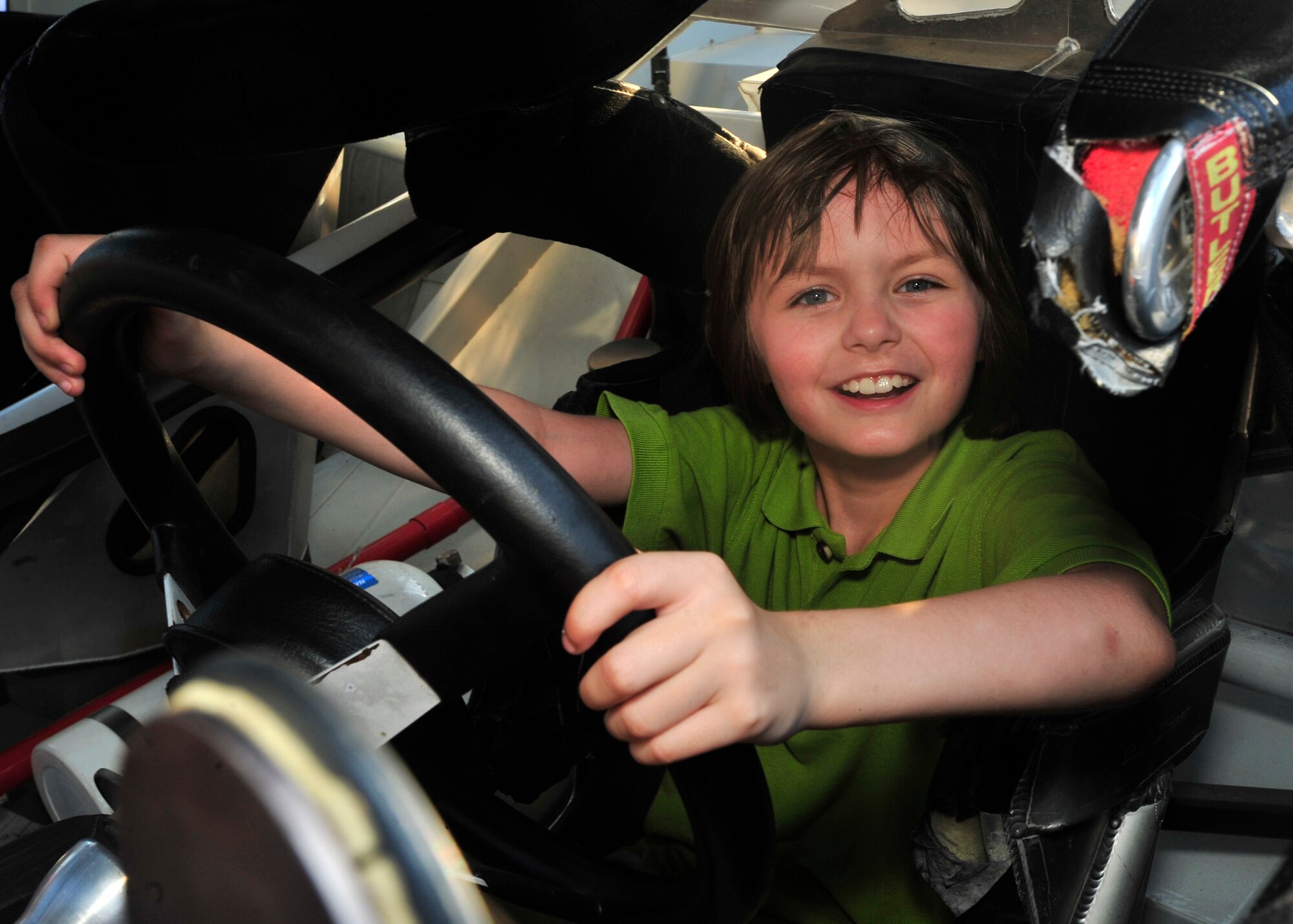 Rachel Walker sits in a NASCAR stock car at the Meet and Greet May 31, 2013, at Mulligans on Dover Air Force Base, Del. The Meet and Greet provided the opportunity for Team Dover members to meet drivers, enjoy free food and ice cream, and see a real race car up close. (U.S. Air Force photo/Tech. Sgt. Chuck Walker)