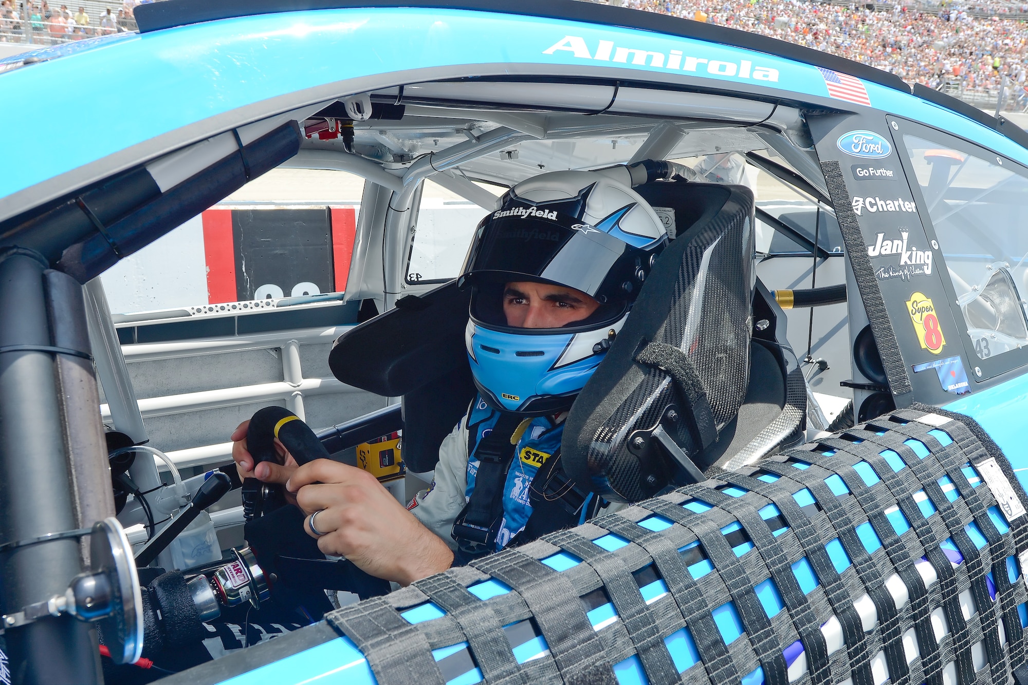 Aric Almirola, driver of the No. 43 Smithfield Foods/U.S. Air Force Ford, sits in his car before the start of the Fed Ex 400 Benefiting Autism Speaks June 2, 2013, at Dover International Speedway in Dover, Del. Almirola, who drives for Richard Petty Motorsports, finished the race in 18th place. (U.S. Air Force photo/Greg L. Davis)