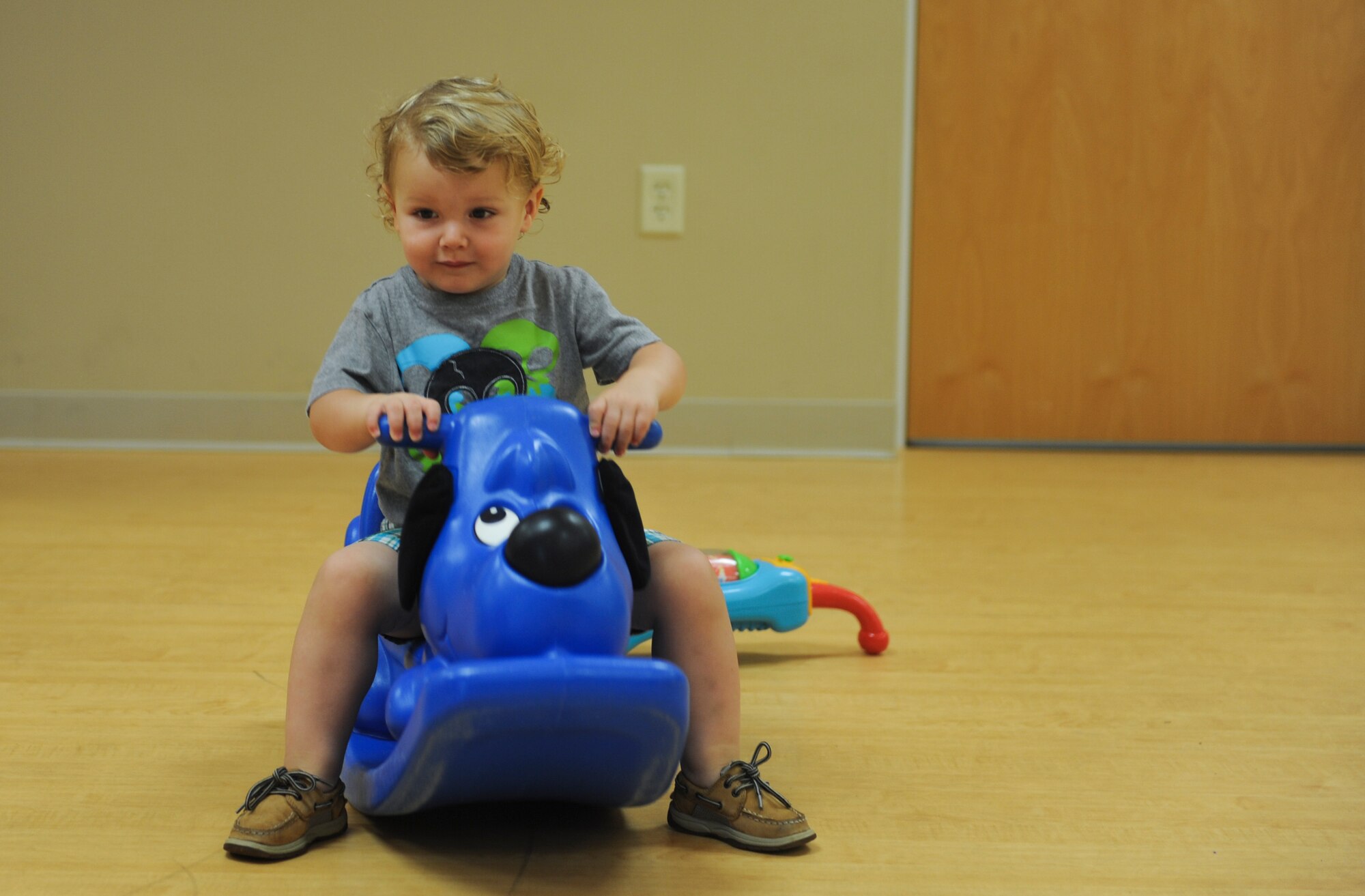 Dominic, son of Tech. Sgt. Eric Ybarra, 23d Equipment Maintenance Squadron production supervisor for conventional maintenance, plays with a toy during the Moody Family Connection Playgroup at Moody Air Force Base, Ga., May 31, 2013. The Moody Family Connection Playgroup lets children interact with one another while their parents socialize. (U.S. Air Force photo by Airman Alexis Grotz/Released)