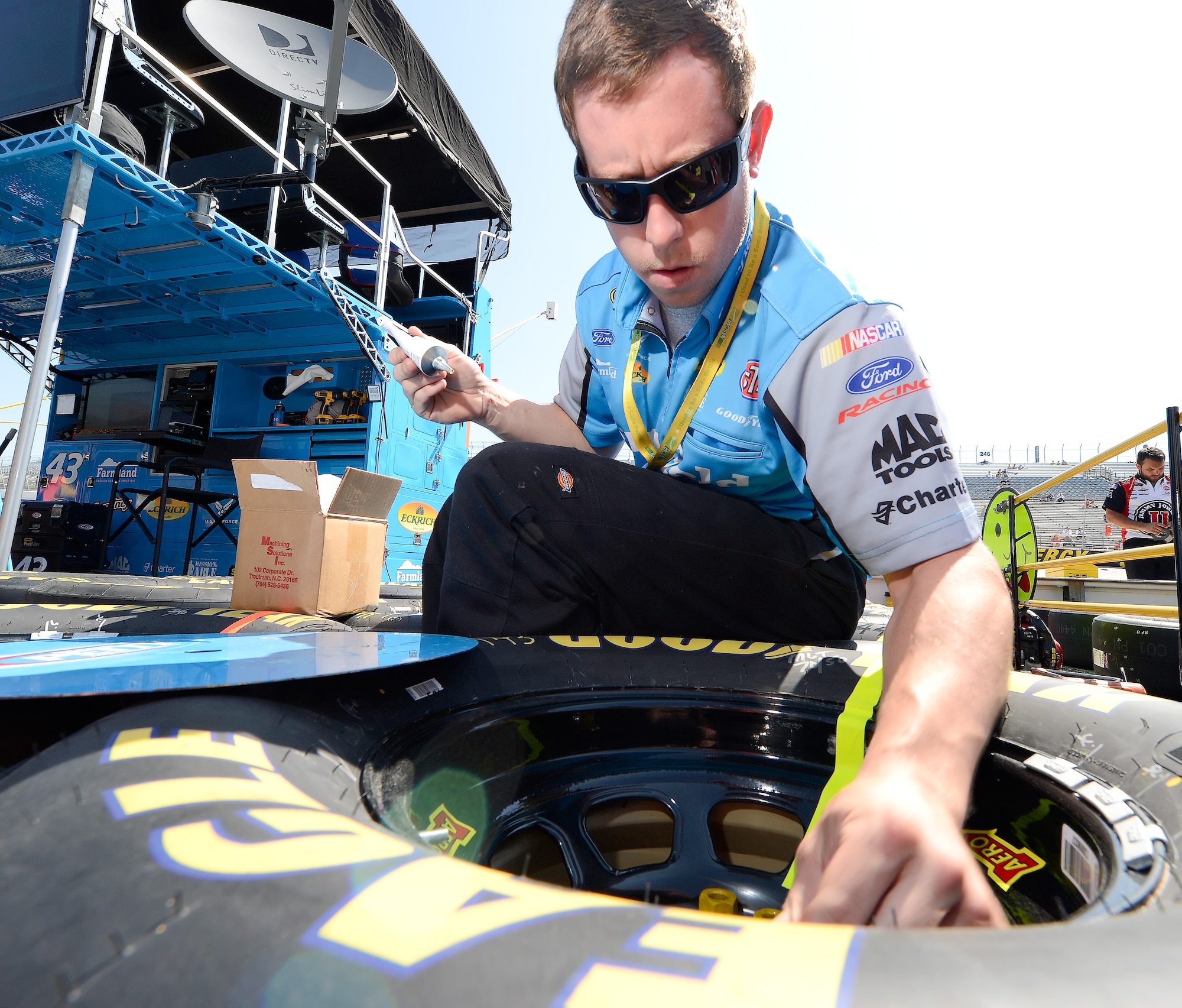 A pit crew member for Aric Almirola, driver of the No. 43 Smithfield Foods/U.S. Air Force Ford, works on one of his tires before the start of the Fed Ex 400 Benefiting Autism Speaks June 2, 2013, at Dover International Speedway in Dover, Del. Almirola, who drives for Richard Petty Motorsports, finished the race in 18th place. (U.S. Air Force photo/Greg L. Davis)
