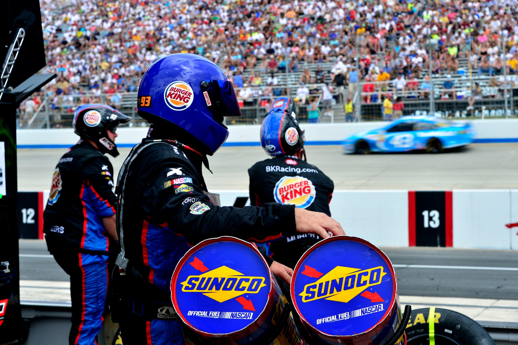 A pit crew member for Travis Kvapil, driver of the No. 93 Burger King/Dr. Pepper Toyota, watches the action during the Fed Ex 400 Benefiting Autism Speaks June 2, 2013, at Dover International Speedway in Dover, Del. Tony Stewart, driver of the No. 14 Mobil One Chevy, won the race. (U.S. Air Force photo/David Tucker)