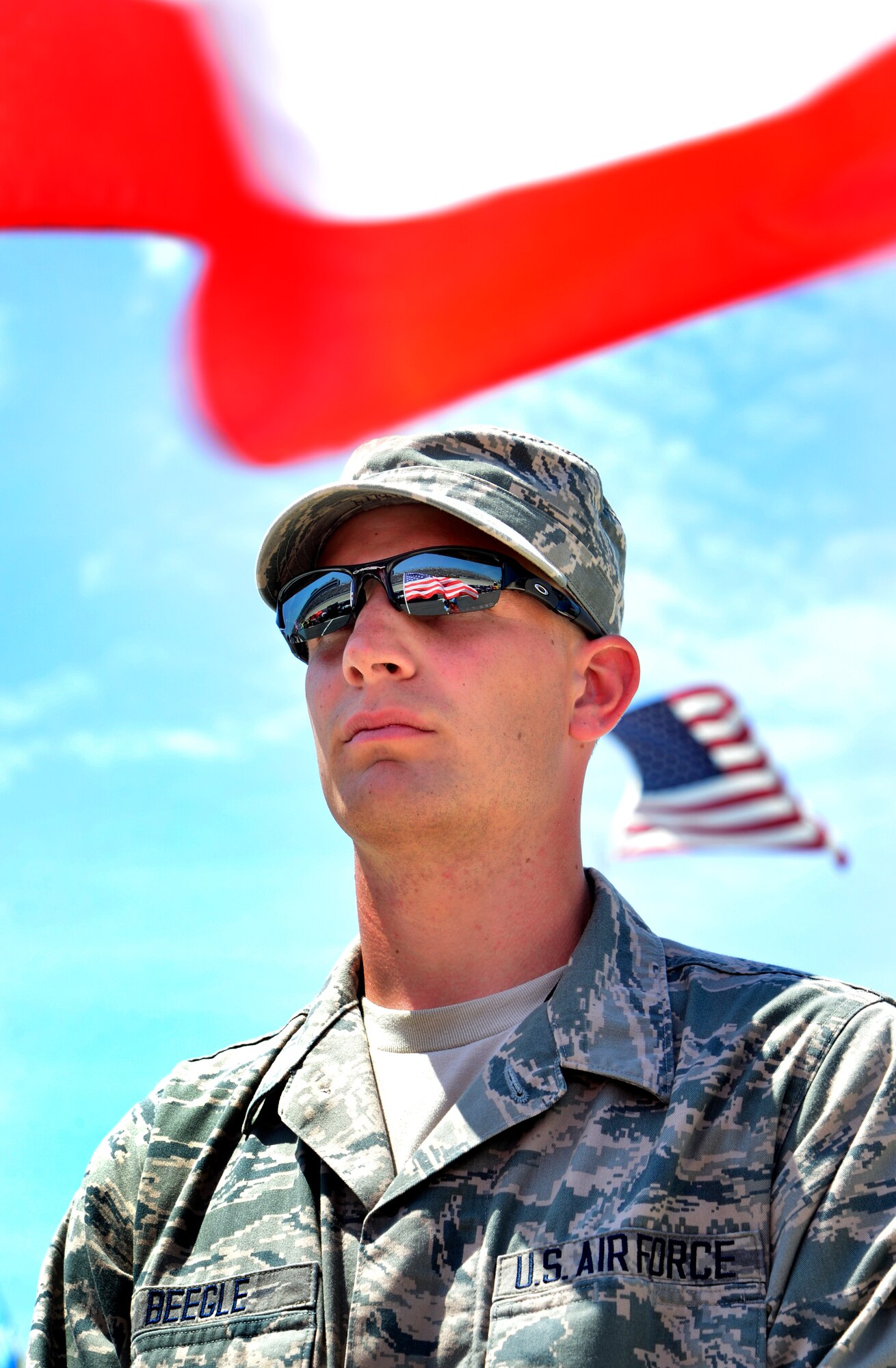 Tech. Sgt. Justin Beegle, 512th Maintenance Squadron, stands at attention during pre-race ceremonies before the start of the Fed Ex 400 Benefiting Autism Speaks June 2, 2013, at Dover International Speedway in Dover, Del. Beegle was part of a large contingent of Team Dover members who took part in various activities during race weekend. (U.S. Air Force photo/David Tucker)