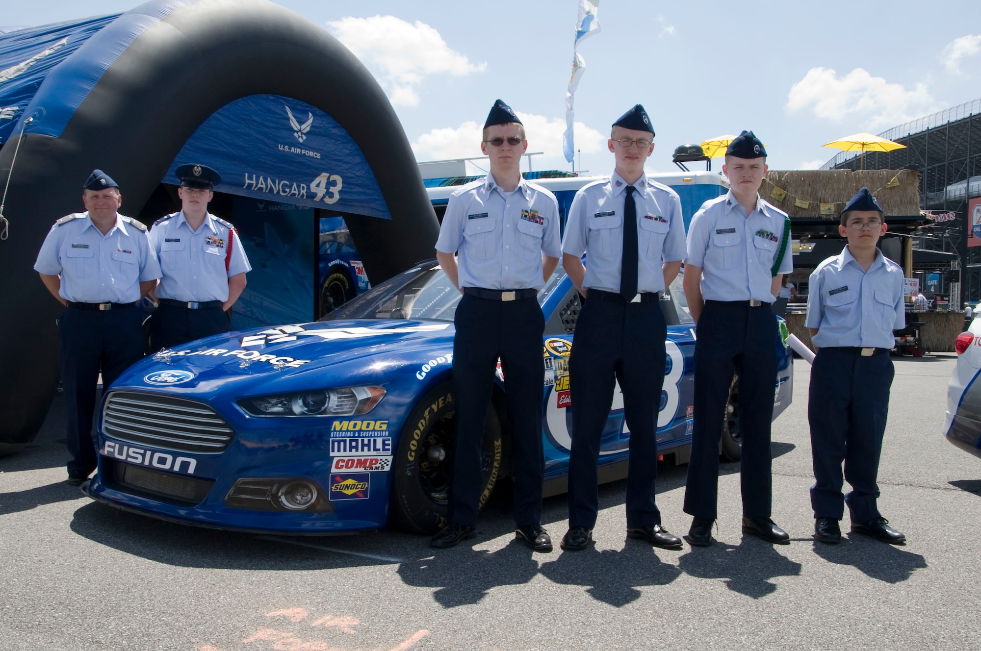 Delaware Civil Air Patrol members pose with the U.S. Air Force sponsored NASCAR stock car at Hangar 43 in the Fun Zone June 1, 2013, at Dover International Speedway, Del. The Civil Air Patrol members were at the event to help the 314th Recruiting Squadron get out the Air Forces message. (U.S. Air Force photo/Senior Airman Jared Duhon)