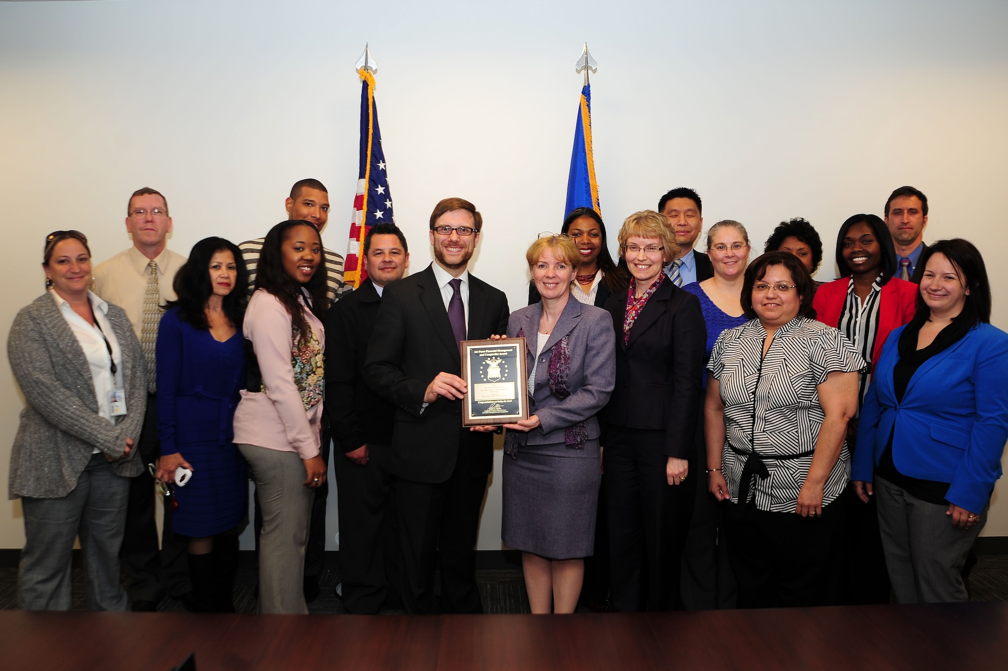 Assistant Secretary of the Air Force Financial Management and Comptroller Dr. Jamie M. Morin presents the Air Force District of Washington Financial Improvement and Audit Readiness Team with the 2012 SAF/FM Special Acts and Services Award, May 14, 2013, at Joint Base Andrews, Md. The FIAR team is comprised of AFDW/FM and Contracting directorates. Over the course of 2012, the team reviewed over 2,000 contracts and successfully closed out in excess of $50 million in aged funds--money which was returned to the U.S. Treasury and U.S. Air Force for reuse. (U.S. Air Force photo by Senior Airman Steele C. G. Britton)