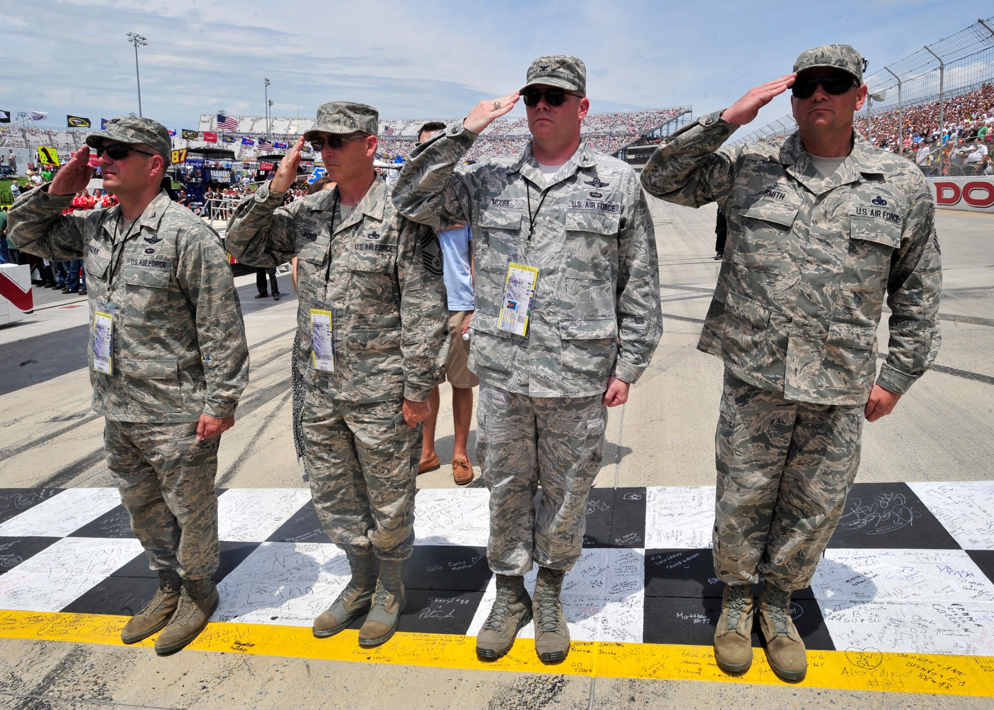 (from left) Col. Raymond Kozak, 512th Airlift Wing commander, Chief Master Sgt. Bryan Ford, 512th Maintenance Group chief enlisted manager, Col. Rick Moore, 436th AW commander and Chief Master Sgt. Jim Smith, 436th AW command chief, salute during the National Anthem before the start of the Fed Ex 400 Benefiting Autism Speaks June 2, 2013, at Dover International Speedway in Dover, Del. The Dover AFB leadership took part in pre-race ceremonies which included a parade lap. (U.S. Air Force photo/Tech. Sgt. Chuck Walker)
