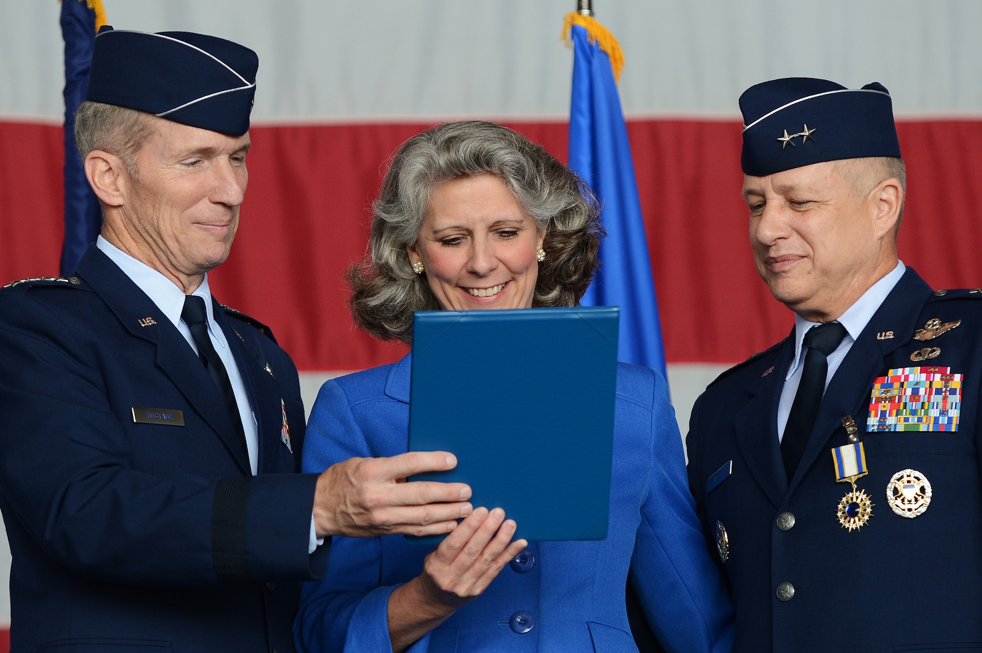 Gen. Mike Hostage, commander of Air Combat Command, presents Kathy Wells, wife of Maj. Gen. Lawrence Wells, 9th Air Force commander, with a certificate of appreciation for the dedicated support of her husband and the Air Force mission, during Well’s retirement ceremony at Shaw Air Force Base, S.C., May 31, 2013. Well’s retirement ceremony followed the 9th Air Force change of command ceremony. (U.S. Air Force photo by Airman 1st Class Daniel Blackwell/Released)
