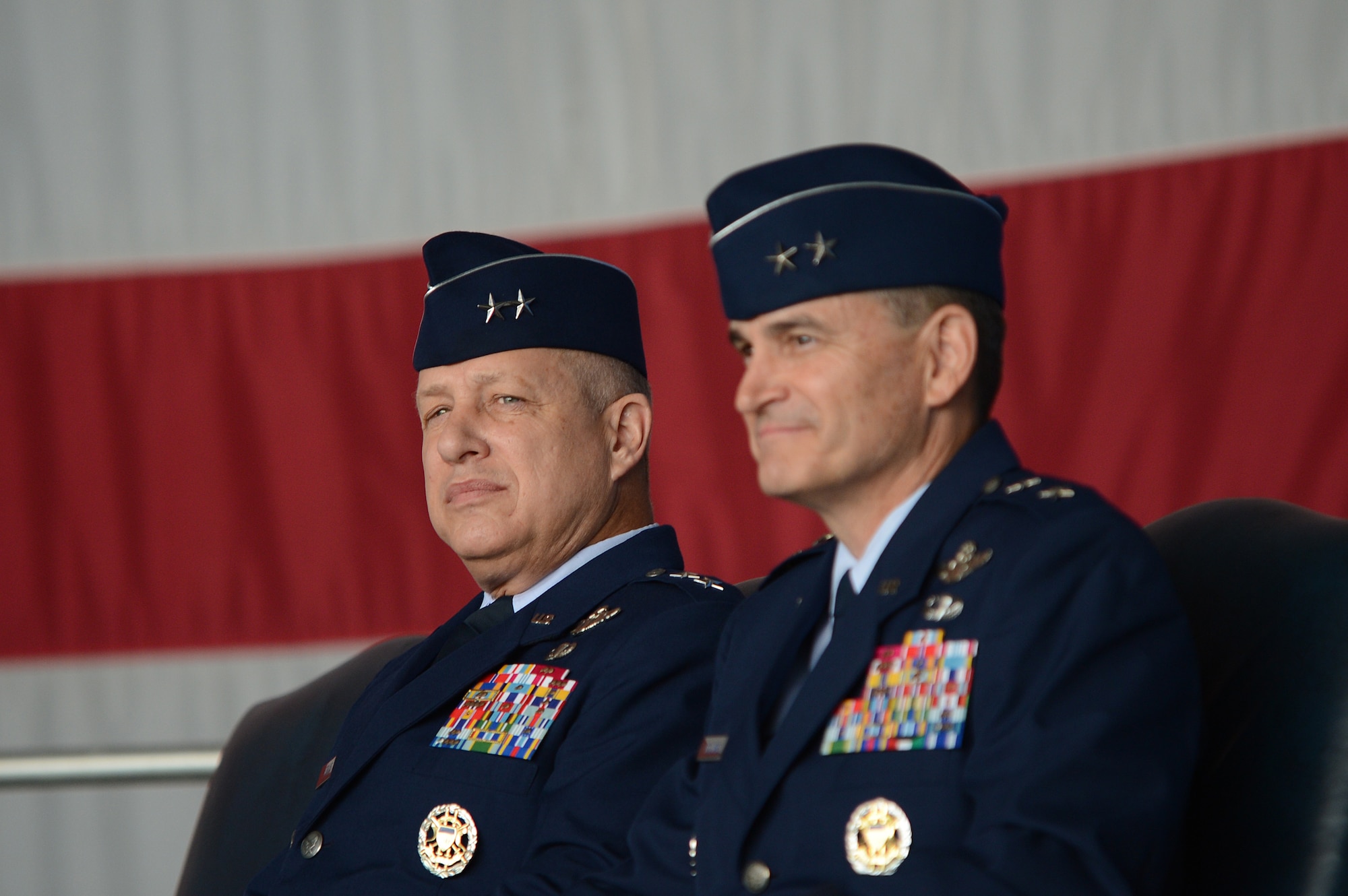 Maj. Gen. Lawrence Wells (left), and Maj. Gen. Jake Polumbo sit and listen during their change of command ceremony at Shaw Air Force Base, S.C., May 31, 2013. Polumbo took command of 9th Air Force from Wells. Wells retired after 35 years of active duty service in the United States Air Force. (U.S. Air Force photo by Airman 1st Class Daniel Blackwell/Released)