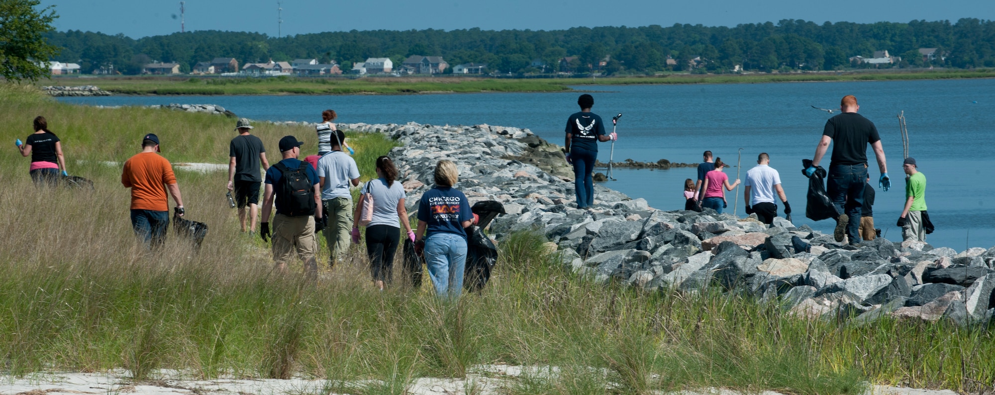 Participants in Clean the Bay Day scout the shoreline for trash at Langley Air Force Base, Va., June 1, 2013. The event usually sees more than 100 volunteers to help clean the bay annually. (U.S. Air Force photo by Airman 1st Class Kimberly Nagle/Released)