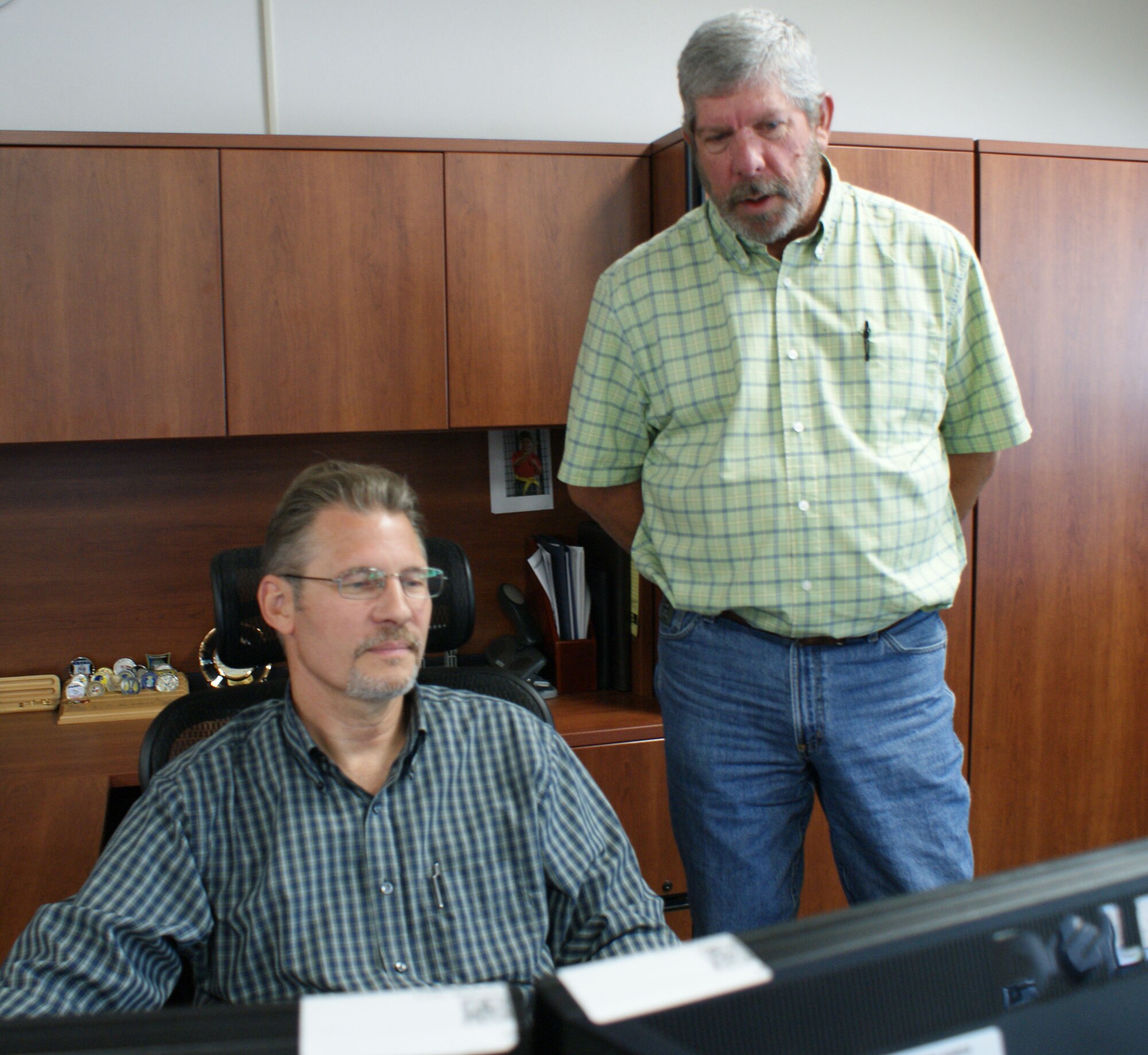 Joseph Rock (right), 365th Training Squadron training support flight chief, talks with Archie Pedigo, 365th TRS, about civilian education opportunities at Sheppard Air Force Base, Texas, June 3, 2013.  Rock began a voluntary unit-wide civilian development program in January 2011 to help employee's learn how to get advance in their civil service careers. (U.S. Air Force photo/Dan Hawkins)