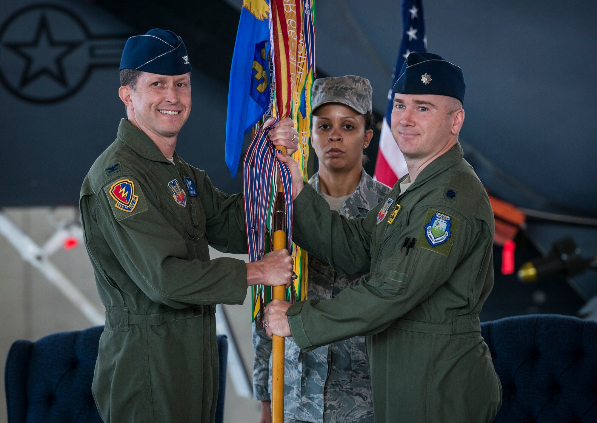 U.S. Air Force Col. Chris Sage (left), 366th Operations Group commander, presents the 391st Fighter Squadron guidon to Lt. Col. Richard Dickens, signifying the transfer of the squadron's command to Dickens May 23, 2013, at Mountain Home Air Force Base, Idaho. The traditional passing of the guidon dates back to medieval times when leaders would carry the banners of their kingdoms to lead their soldiers into battle. (U.S. Air Force Photo by Tech. Sgt. Samuel Morse)(Released)