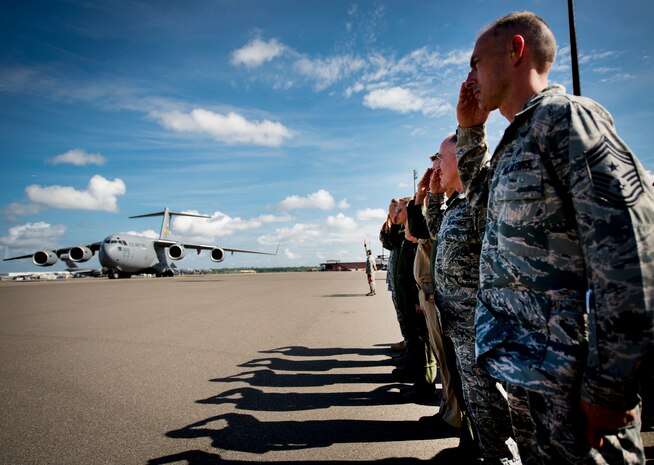 Joint Base Charleston leadership salutes as Lt. Gen. Robert Allardice, Air Mobility Command vice commander delivers the second to last C-17 Globemaster III May 30, 2013, to JB Charleston – Air Base, S.C. Joint Base Charleston is scheduled to receive the final C-17 later this year, as Boeing completes work on the Air Force’s last Globemaster. The first C-17 to enter the Air Force’s inventory arrived at Charleston Air Force Base in June 1993. The C-17 is capable of rapid strategic delivery of troops and all types of cargo to main operating bases or directly to forward bases in the deployment area. (U.S. Air Force photo/Staff Sgt. Rasheen Douglas)