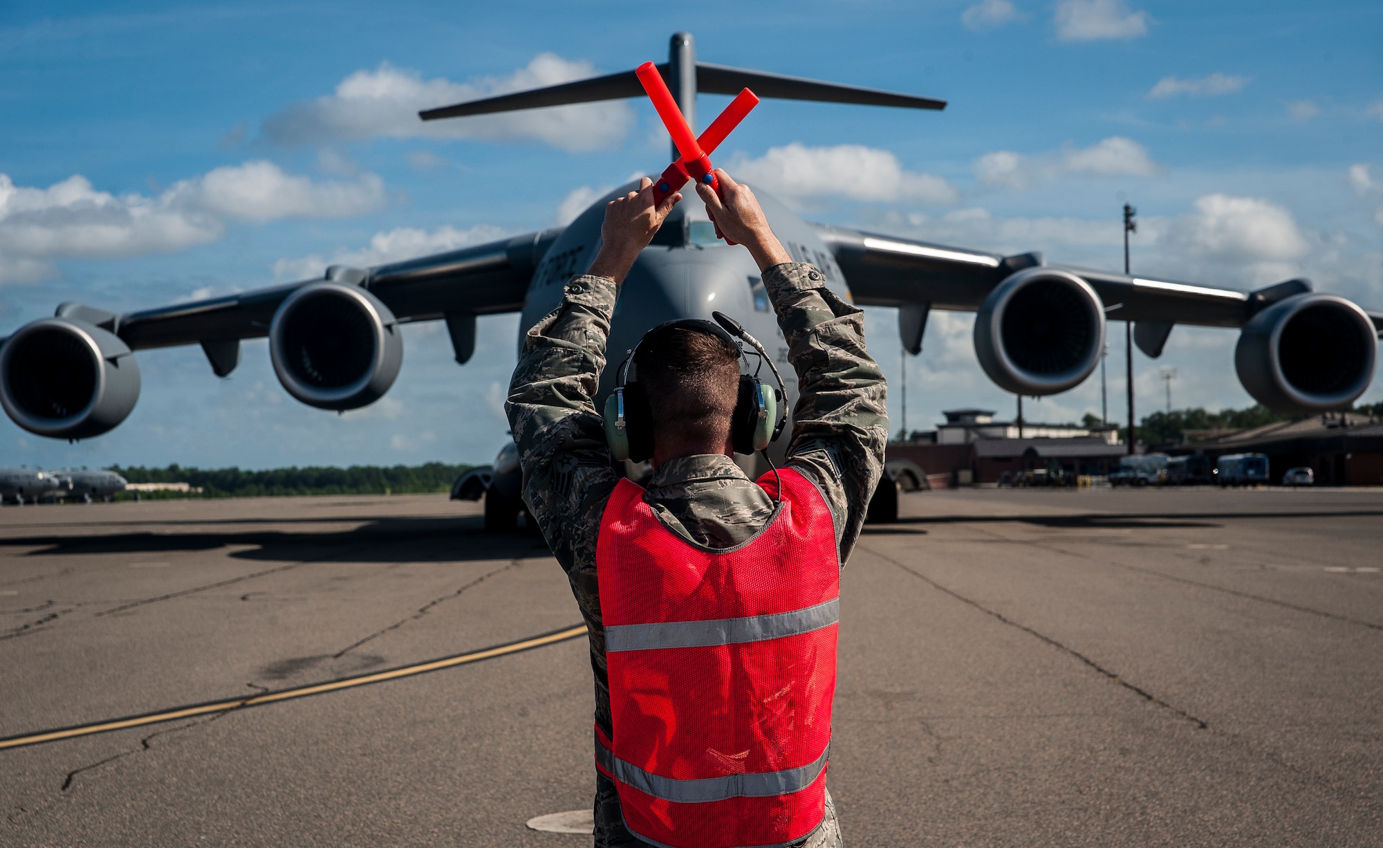 Senior Airman Jay O’Neil, 437th Aircraft Maintenance Squadron crew chief, marshals in a brand new C-17 Globemaster III piloted by Lt. Gen. Robert Allardice, Air Mobility Command vice commander, May 30, 2013, at Joint Base Charleston – Air Base, S.C.  Joint Base Charleston is scheduled to receive the final C-17 later this year, as Boeing completes work on the Air Force’s last Globemaster. The first C-17 to enter the Air Force’s inventory arrived at Charleston Air Force Base in June 1993. The C-17 is capable of rapid strategic delivery of troops and all types of cargo to main operating bases or directly to forward bases in the deployment area. (U.S. Air Force photo/Senior Airman Dennis Sloan)
