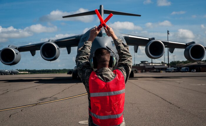 Senior Airman Jay O’Neil, 437th Aircraft Maintenance Squadron crew chief, marshals in a brand new C-17 Globemaster III piloted by Lt. Gen. Robert Allardice, Air Mobility Command vice commander, May 30, 2013, at Joint Base Charleston – Air Base, S.C.  Joint Base Charleston is scheduled to receive the final C-17 later this year, as Boeing completes work on the Air Force’s last Globemaster. The first C-17 to enter the Air Force’s inventory arrived at Charleston Air Force Base in June 1993. The C-17 is capable of rapid strategic delivery of troops and all types of cargo to main operating bases or directly to forward bases in the deployment area. (U.S. Air Force photo/Senior Airman Dennis Sloan)