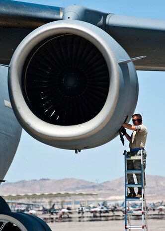 U.S. Air Force Staff Sgt. Isaac Beagle, 62nd Aircraft Maintenance Squadron crew chief, McChord Air Force Base, Wash., conducts maintenance on a C-17 Globemaster III after the Joint Forcible Entry exercise May 31, 2013, at Nellis Air Force Base, Nev. Nine C-17s from various squadrons participated in the exercise. (U.S. Air Force photo/Senior Airman Brett Clashman)