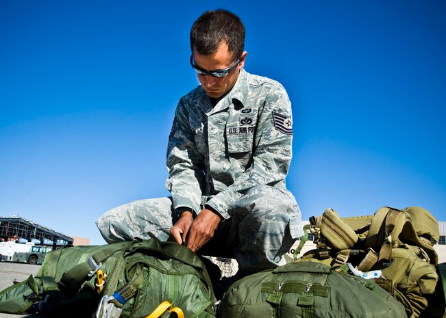 Tech. Sgt. Joshua Ramos, 820th RED HORSE airborne electrical systems technician, checks his equipment before boarding a C-130 Hercules May 31, 2013, at Nellis Air Force Base, Nev. Ramos was a participant in the Joint Forcible Entry Exercise. (U.S. Air Force photo by Airman 1st Class Jason Couillard)