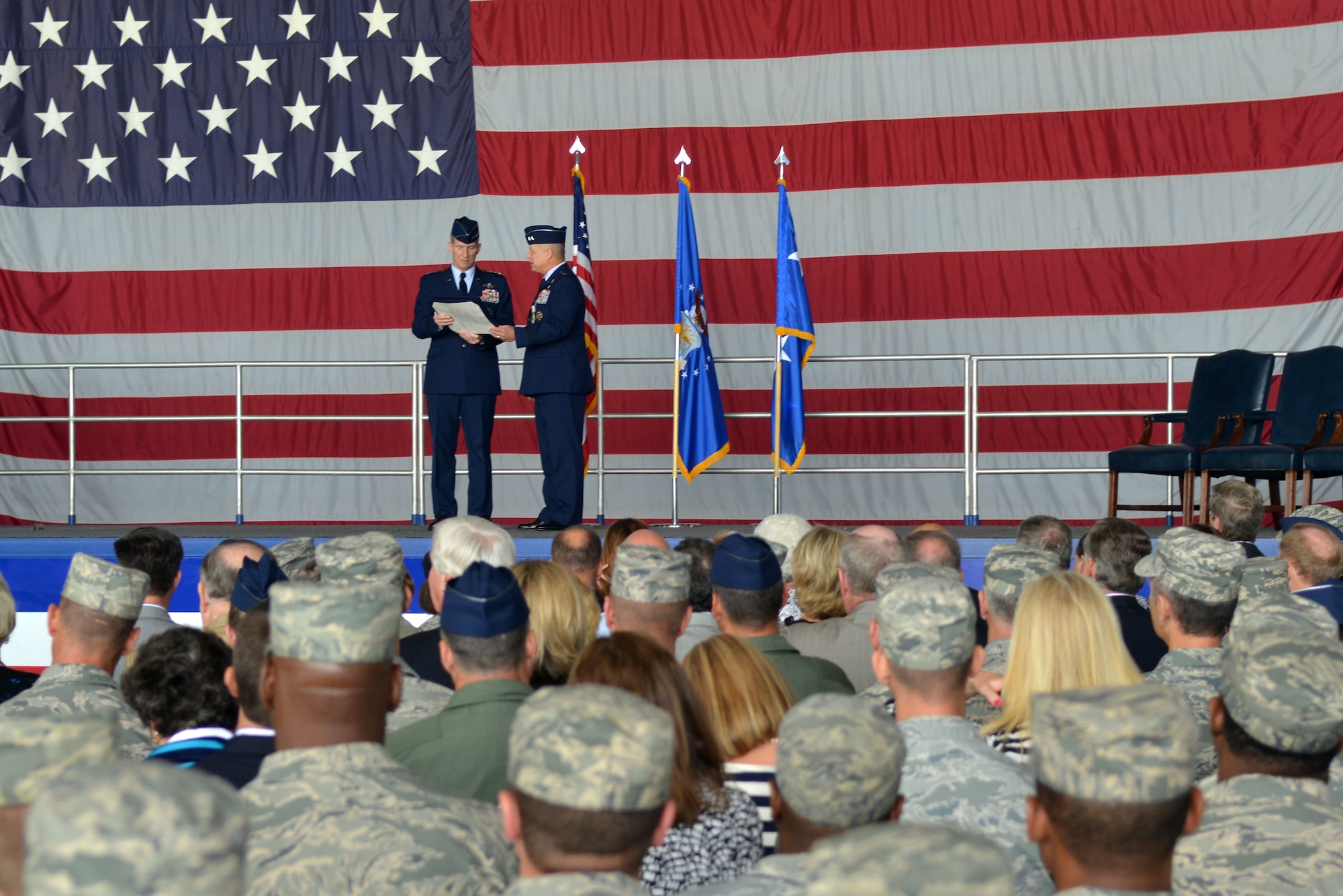 U.S. Air Force Gen. Mike Hostage, commander of Air Combat Command, presents Maj. Gen. Lawrence Wells, 9th Air Force commander, with his retirement certificate, Shaw Air Force Base, S.C., May 31, 2013. Wells officially retired after serving 35 years of military service. (U.S. Air Force photo by Airman 1st Class Ashley L. Gardner/Released))