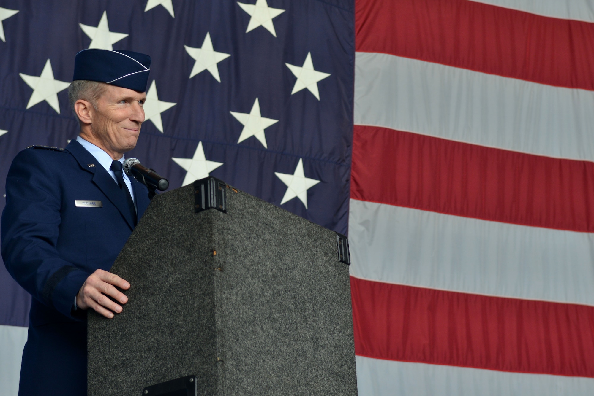 U.S. Air Force Gen. Mike Hostage, commander of Air Combat Command, stands at the podium during a 9th Air Force change of command ceremony, Shaw Air Force Base, S.C., May 31, 2013. Hostage and his wife Kathy, toured the 20th Fighter Wing to visit with Airmen and get a first-hand look at Shaw’s mission capabilities. (U.S. Air Force photo by Airman 1st Class Ashley L. Gardner/Released)