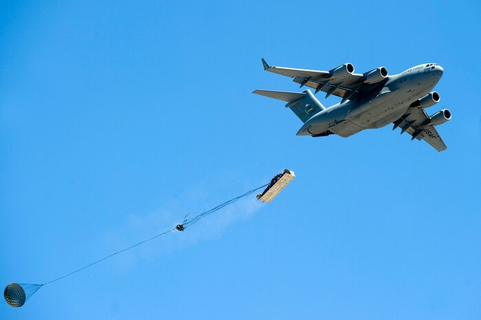 A C-17 Globemaster III from the 62nd Airlift Wing drops military cargo May 31, 2013, during the Joint Forcible Entry Exercise on the Nevada Test and Training Range. The cargo contained equipment necessary for the JFEX. (U.S. Air Force photo by Senior Airman Matthew Lancaster)