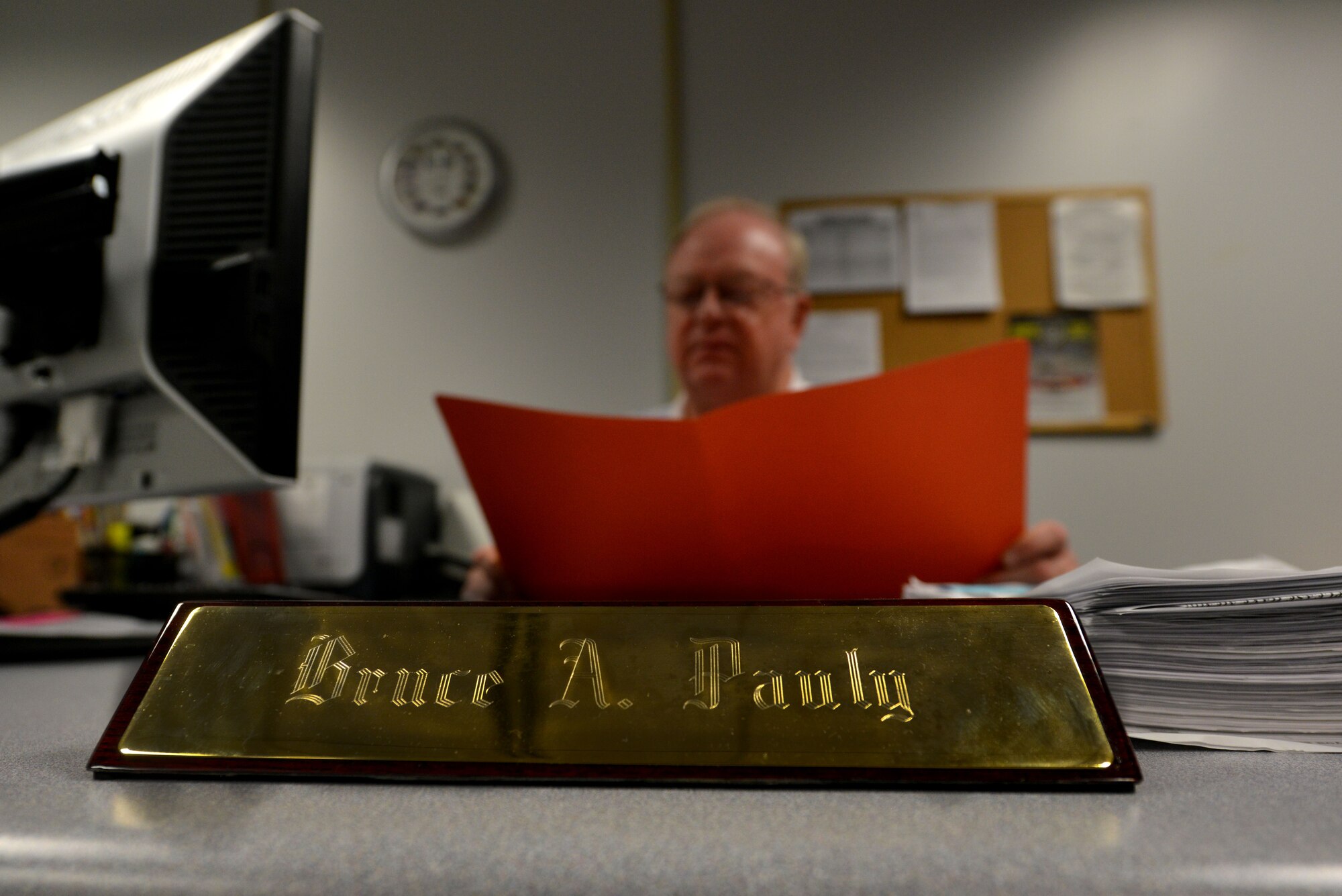 Bruce Pauly, 20th Logistics Readiness Squadron passenger travel chief, sorts through paperwork for the commercial travel office, Shaw Air Force Base, S.C., June 4, 2013. The CTO recently had a change in partnering travel companies. WingGate Travel replaced Rodgers Travel as the supporting company for the CTO at Shaw. (U.S. Air Force photo by Airman 1st Class Ashley L. Gardner/Released)