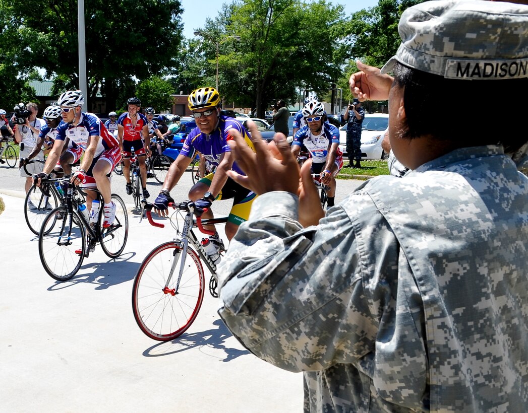 U.S. Army Staff Sgt. Jobina Madison, Fort Eustis, Va., Warrior Transition Unit squad leader, cheers as approximately 200 Ride 2 Recovery cyclists finished their day’s ride and arrived at the WTU, May 31, 2013. The cyclists participated in a multi-day ride from Washington, D.C. to Virginia Beach, Va., which was designed to push the riders to their limit both physically and mentally as part of their recovery process. (U.S. Air Force photo by Staff Sgt. Wesley Farnsworth / Released)  