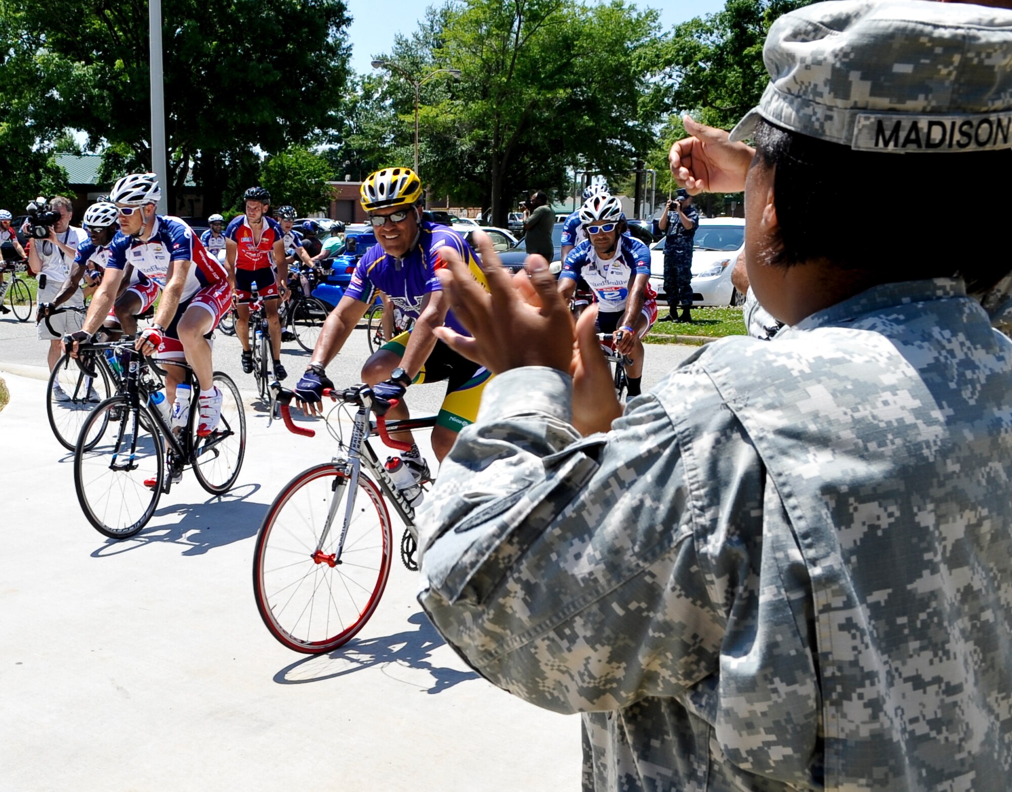 U.S. Army Staff Sgt. Jobina Madison, Fort Eustis, Va., Warrior Transition Unit squad leader, cheers as approximately 200 Ride 2 Recovery cyclists finished their day’s ride and arrived at the WTU, May 31, 2013. The cyclists participated in a multi-day ride from Washington, D.C. to Virginia Beach, Va., which was designed to push the riders to their limit both physically and mentally as part of their recovery process. (U.S. Air Force photo by Staff Sgt. Wesley Farnsworth / Released)  