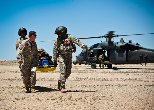 The 82nd Airborne Division Medical Evacuation Team prepares to conduct a medical evacuation on an injured soldier May 31, 2013, during the Joint Forcible Entry Exercise on the Nevada Test and Training Range, Nev. During the exercise soldiers simulated parachuting into a hostile environment in order to achieve their strategic objectives. (U.S. Air Force photo by Staff Sgt. Michael Charles)