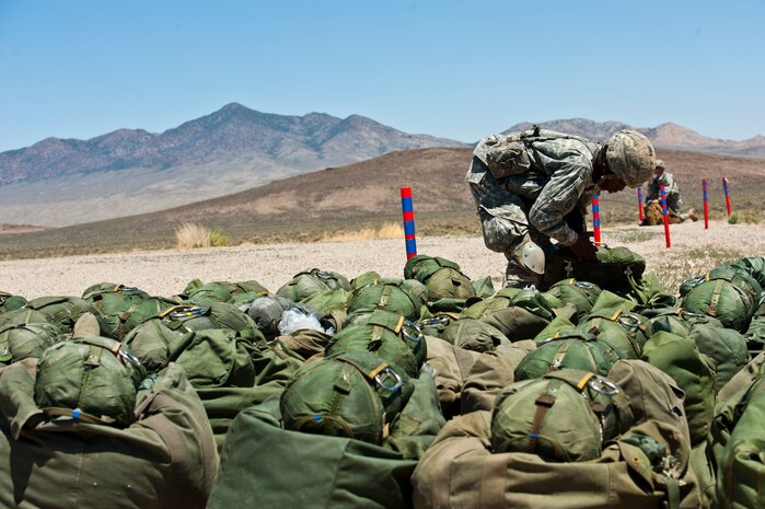 U.S. Army Specialist Waverlyn Lang, 82nd Airborne Division 3rd Brigade Combat Team member, conducts an equipment inspection, May 31, 2013, during the Joint Forcible Entry Exercise on the Nevada Test and Training Range, Nev. Joint service exercises like the JFEX are integral to maintaining operational cohesiveness between the Air Force and the Army. (U.S. Air Force photo by Staff Sgt. Michael Charles)