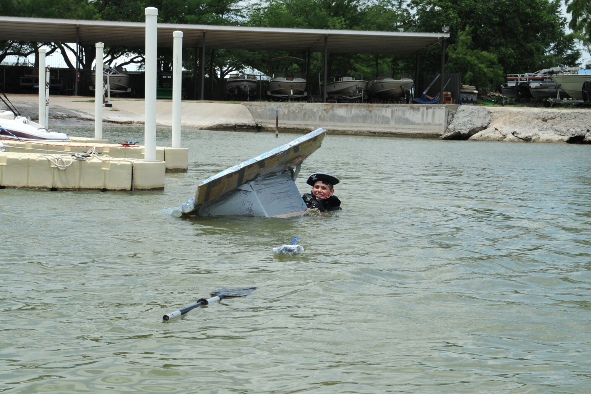 GOODFELLOW AIR FORCE BASE, Texas -- A youth looks back after rocking his boat too much during the Build a Boat contest at the Goodfellow Recreation Camp, May 27. The contest required the boats be made of cardboard, duct tape and milk jugs. (U.S. Air Force photo by Staff Sgt. Laura R. McFarlane)