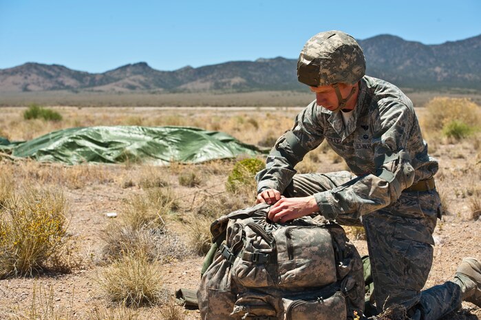 U.S Air Force Maj. Patrick Foley, 14th Air Support Operations Squadron air liaison officer, gathers his equipment following an air-to-ground jump May 31, 2013, during the Joint Forcible Entry Exercise on the Nevada Test and Training Range, Nev. Airmen from the 14th ASOS at Pope Army Air Field, N.C. provide air and space power expertise and integration to the 82nd Airborne Division. (U.S. Air Force photo by Staff Sgt. Michael Charles)