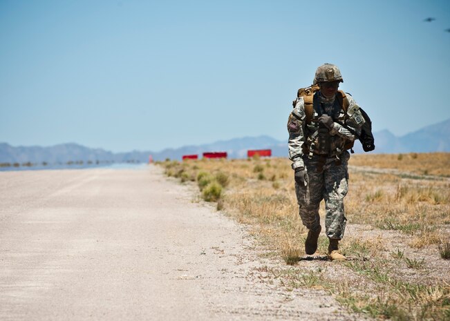 U.S. Army Sgt. 1st Class Jonathan Bradford, 82nd Airborne Division 3rd Brigade Combat Team member, conducts a runway inspection May 31, 2013, during the Joint Forcible Entry Exercise on the Nevada Test and Training Range, Nev. One hundred-forty service members from the 820th RED HORSE Squadron at Nellis Air Force Base, Nev. and the 82nd Airborne at Fort Bragg conducted air drops during the exercise. (U.S. Air Force photo by Staff Sgt. Michael Charles)
