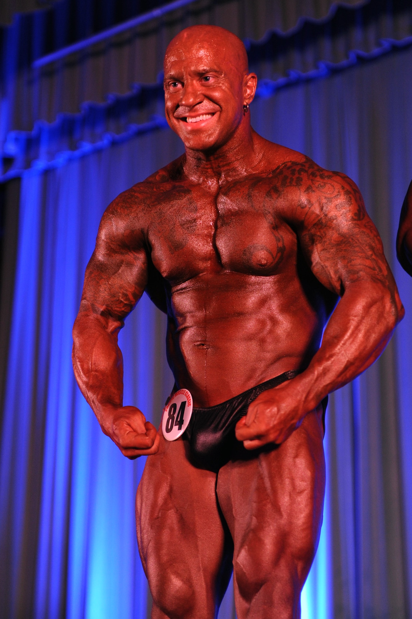 Christopher Martin, Naval Air Facility, Atsugi, Japan, Health and Wellness manager, flexes during a pose-off at the 2013 Pacific Muscle Classic at the Keystone Theater on Kadena Air Base, Japan, June 2, 2013. Martin took home first place in the male bodybuilders light-heavyweight category and has been training for approximately 16 years. (U.S. Air Force photo by Airman 1st Class Hailey R. Davis/Released)