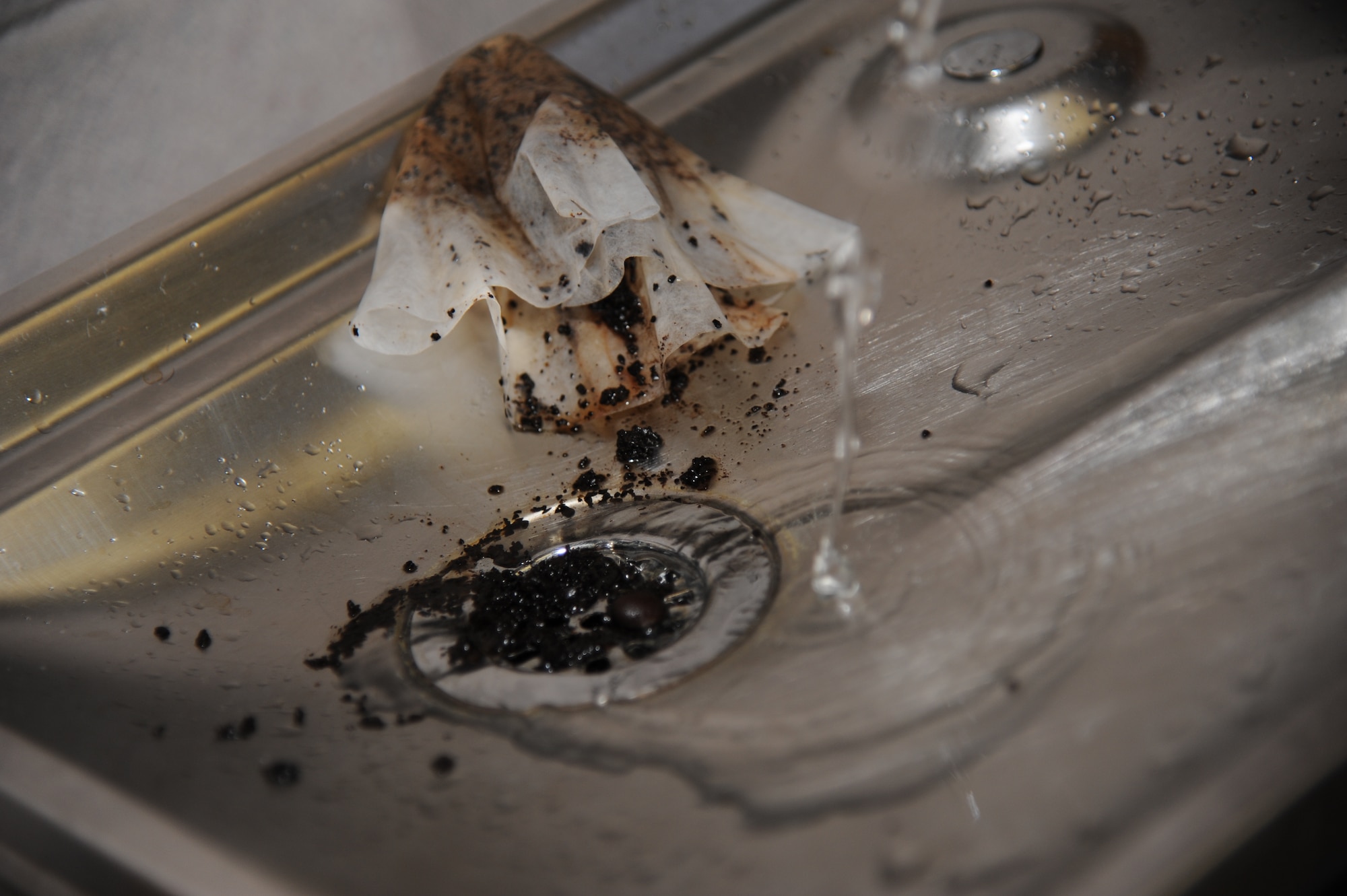 Coffee grounds are placed in a water fountain which will prevent proper drainage and may stick to other substances that can cause sewage backups.  There have been three major sewage backups within two months in which small amounts of raw sewage were actually running the streets at Keesler Air Force Base, Miss.  Bags, wrappers, solvents, paints and flammable and corrosive substances are also being improperly disposed of into some workplace and residential drains.  (U.S. Air Force photo by Kemberly Groue)