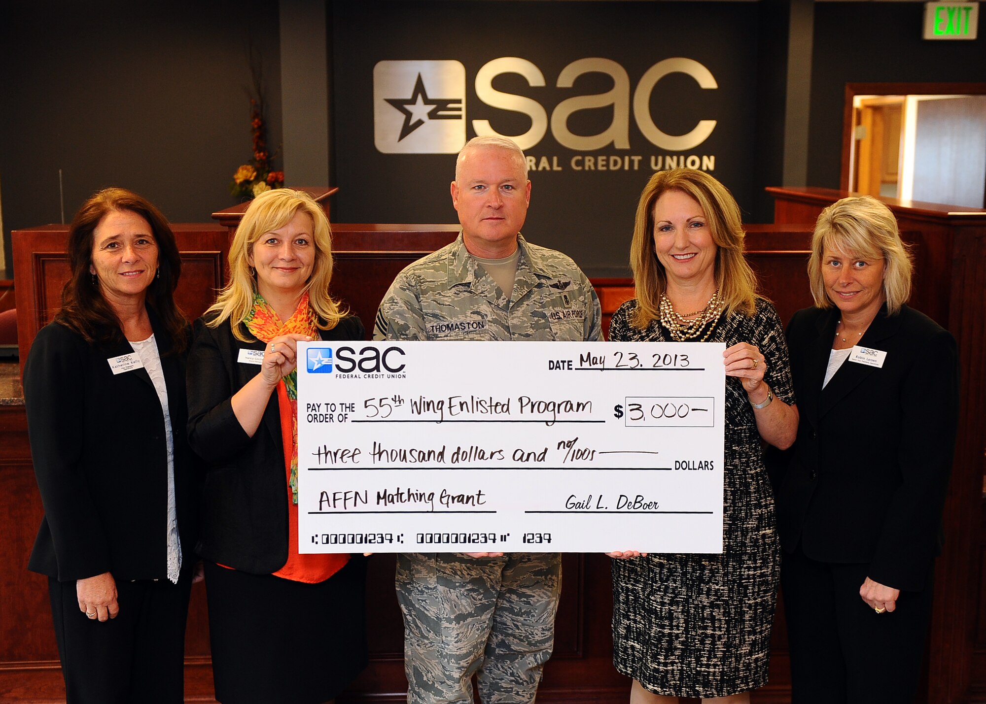 (From left to right)  Katherine Kelly, SAC Federal Credit Union vice president of operations, Nancy Gilchrist, SAC Federal Credit Union Offutt branch manager, U.S. Air Force Chief Master Sgt. William Thomaston, 55th Wing command chief, Gail DeBoer, president and CEO of SAC Federal Credit Union and Robin Larsen, SAC Federal Credit Union senior vice president of operations, present a $3,000 check May 23 for the enlisted fund at Offutt Air Force Base, Neb.  SAC Federal Credit Union has partnered with the Armed Force Financial Network for six consecutive years to raise money for the men and women of Offutt. The $3,000 grant is comprised of a $1,500 dollar donation each by SAC Federal Credit Union and AFFN.  This program offers assistance to help comfort enlisted Offutt military members and their families during their special times of need.  (Photo by Josh Plueger/Released)