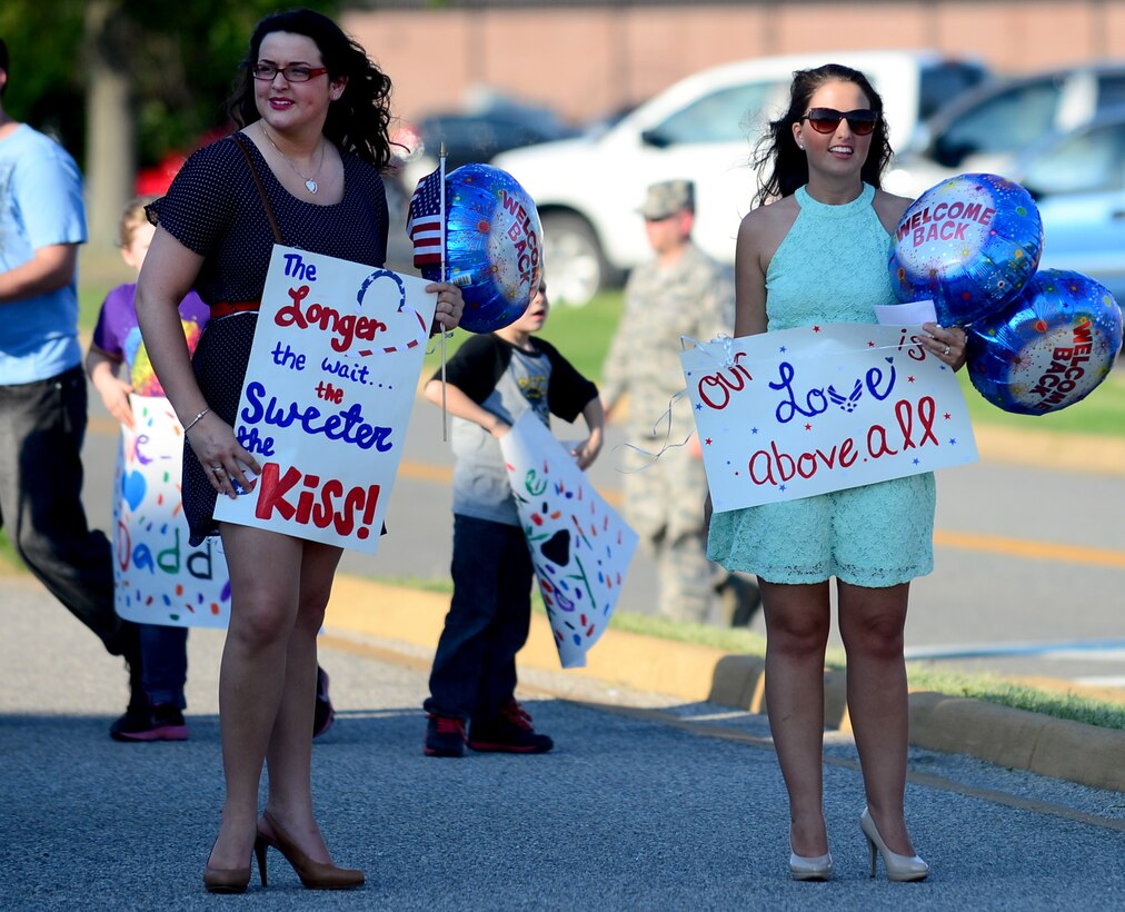 Family members await the arrival of the U.S. Air Force Airmen from the 94th Fighter Squadron and 94th Aircraft Maintenance Unit at Langley Air Force Base, Va., May 29, 2013, following the unit’s five-month deployment to Kadena Air Base, Japan. The 94th FS and 94th AMU deployed 150 Service members in support of the U.S. Pacific Command’s security obligations in the Western Pacific. (U.S. Air Force photo by Senior Airman Kayla Newman/Released)