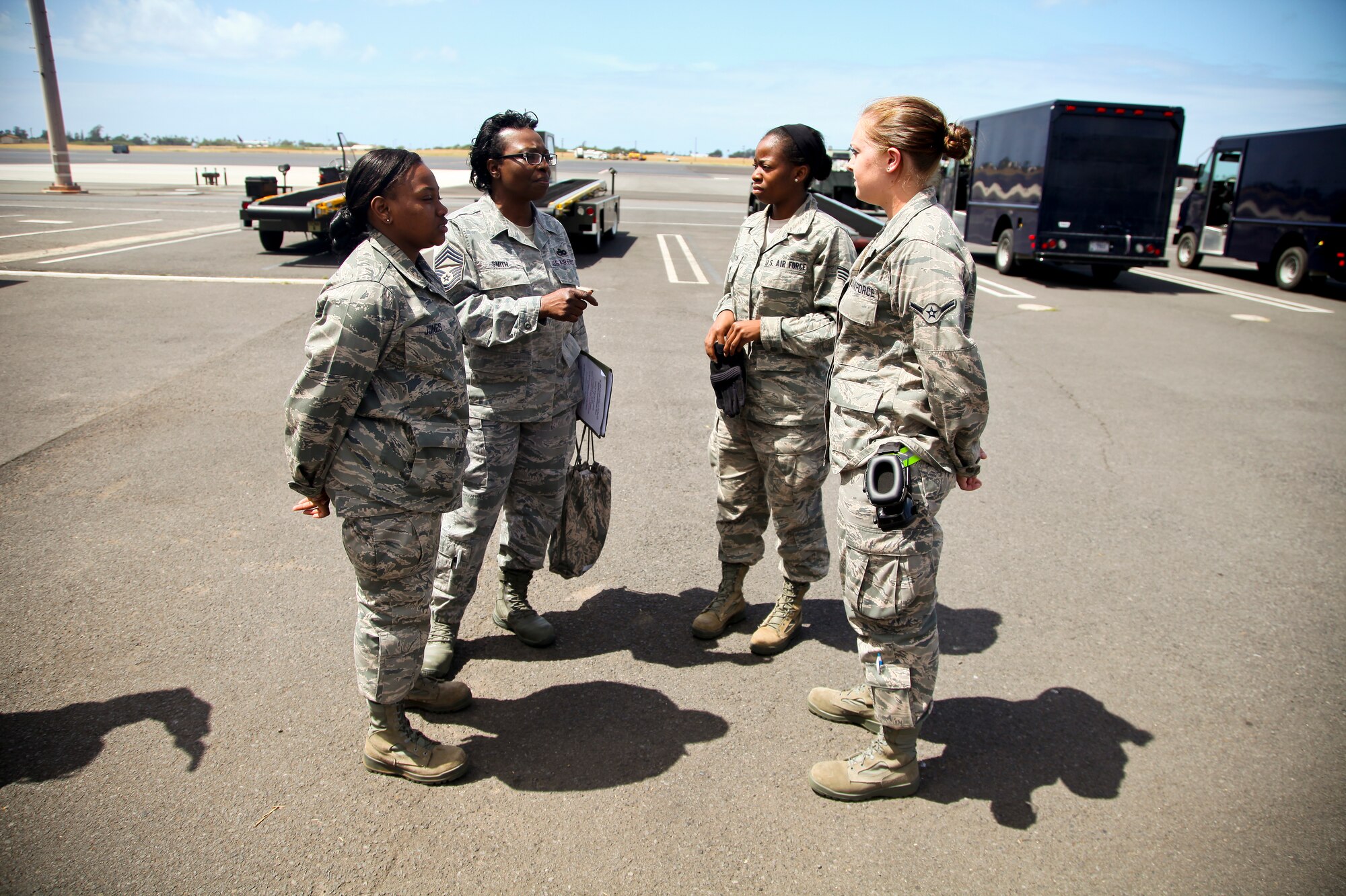 38th Aerial Port Squadron team chief Chief Master Sgt. Linda Smith briefs several passenger operations airmen on today's schedule of operations here on the Joint Base Pearl Harbor-Hickam flight line. (U.S. Air Force photo by Staff Sgt. Rashard Coaxum)